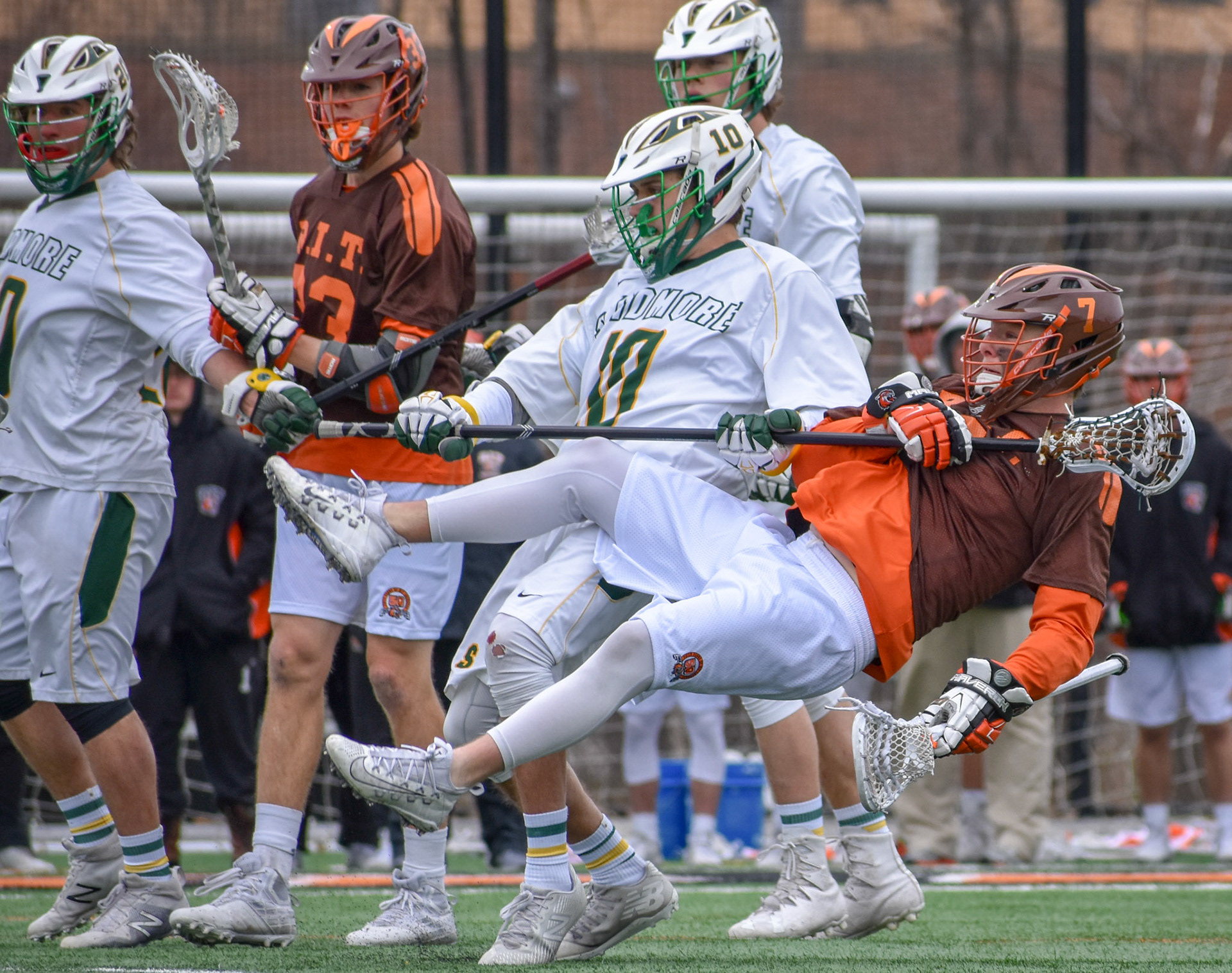 Logan Hart(#10), a long pole from Skidmore Collage knocks Kyle Killen(#7) of RIT of his feet. Killen still is able to make a one handed goal during the 50th anniversary game against Skidmore, on April 14th 2018 at the RIT Turf in Henrietta NY. RIT Won 18-8.