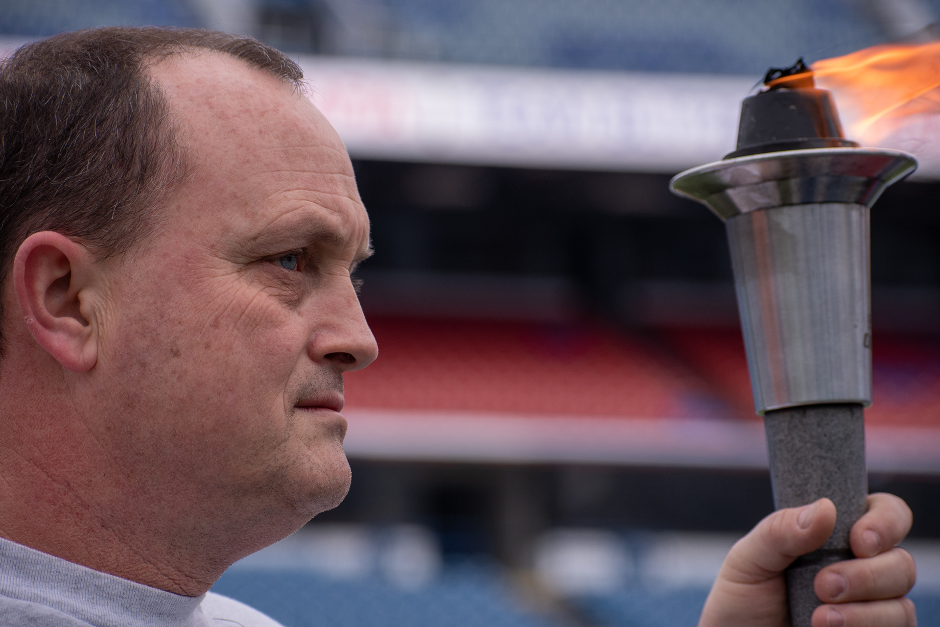 Jeff Wilson carries the torch for the opening ceremonies of The Buffalo Snow Bowl, in benefit of Special Olympics, on March 2nd, 2019,  at New Era Field in Orchard Park New York.  