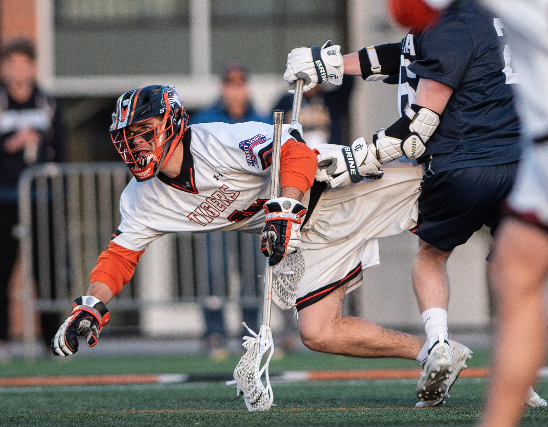 Sophomore Cameron Gebhardt gets tripped in the offensive zone while making a pass during RIT and Ithaca game at the RIT Turf in Rochester NY on April 10th, 2019.  RIT won 18-7.