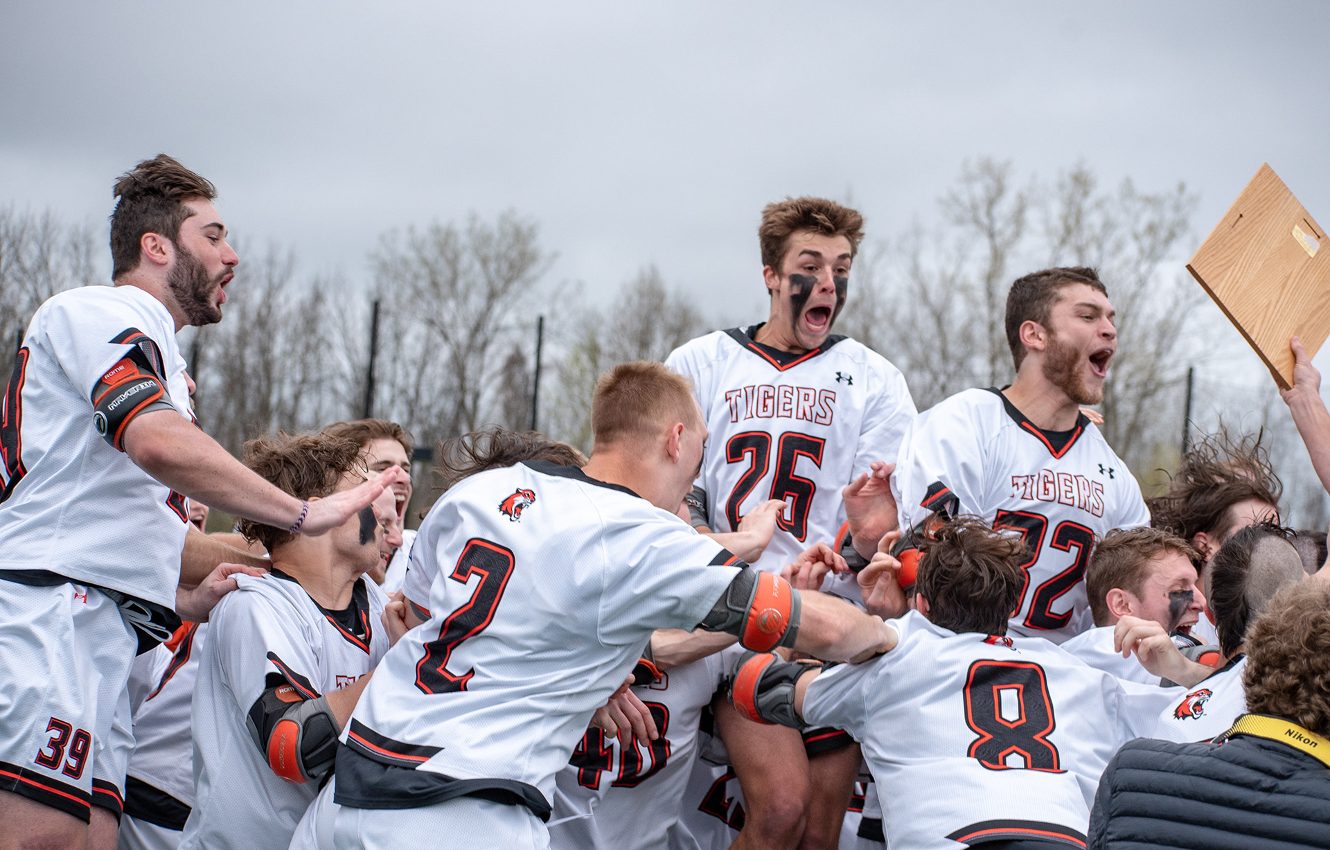 Kyle Sendobry(39), Andrew Powlin (26), Matt Streit(32), all of RIT jump into the dog pile after winning the Liberty League Tournament Championship game against Union College at the RIT Turf in Henrietta NY on May 4th, 2019. RIT Won 14-6.