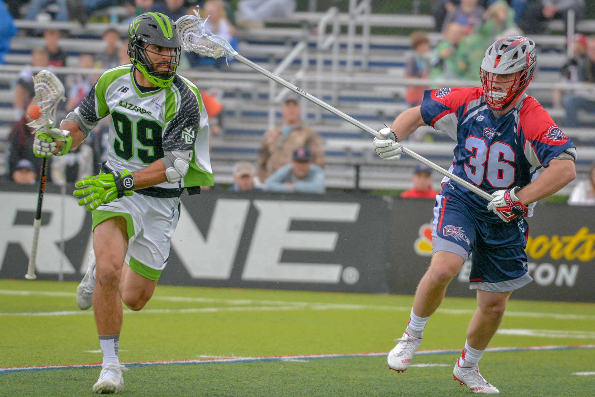 Paul Rabil(99) of the NY Lizards dodges defenseman Tim Muller(36) of the Boston Cannons in the Boston Cannons vs. New York Lizards game on June 23rd at Endicott College in Beverly MA.