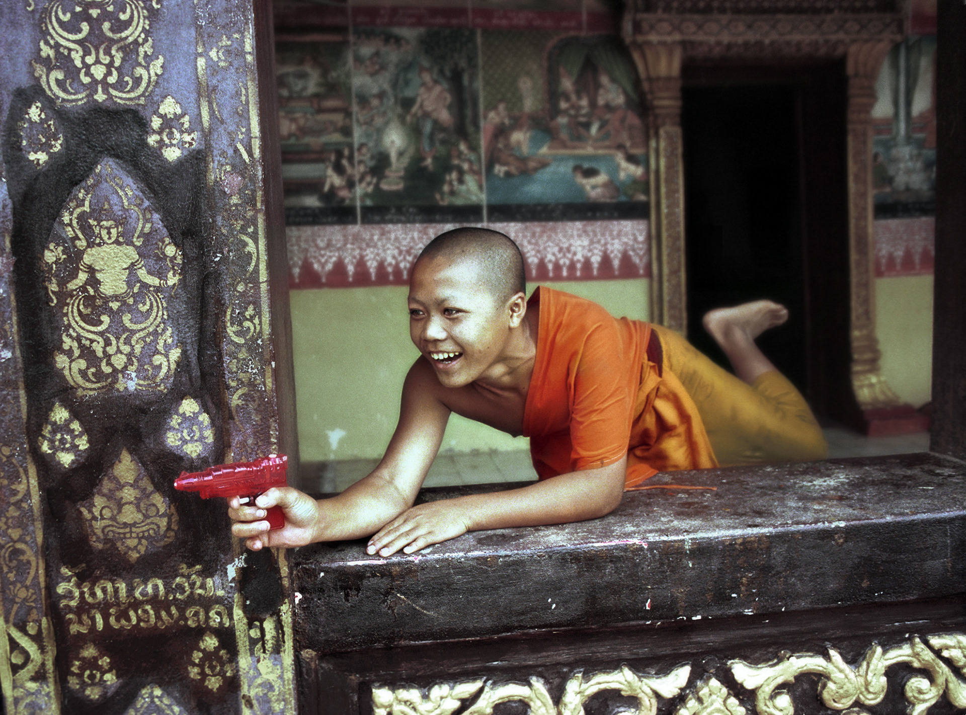 Young monk at play, Water Festival, Luang Prabang, Laos