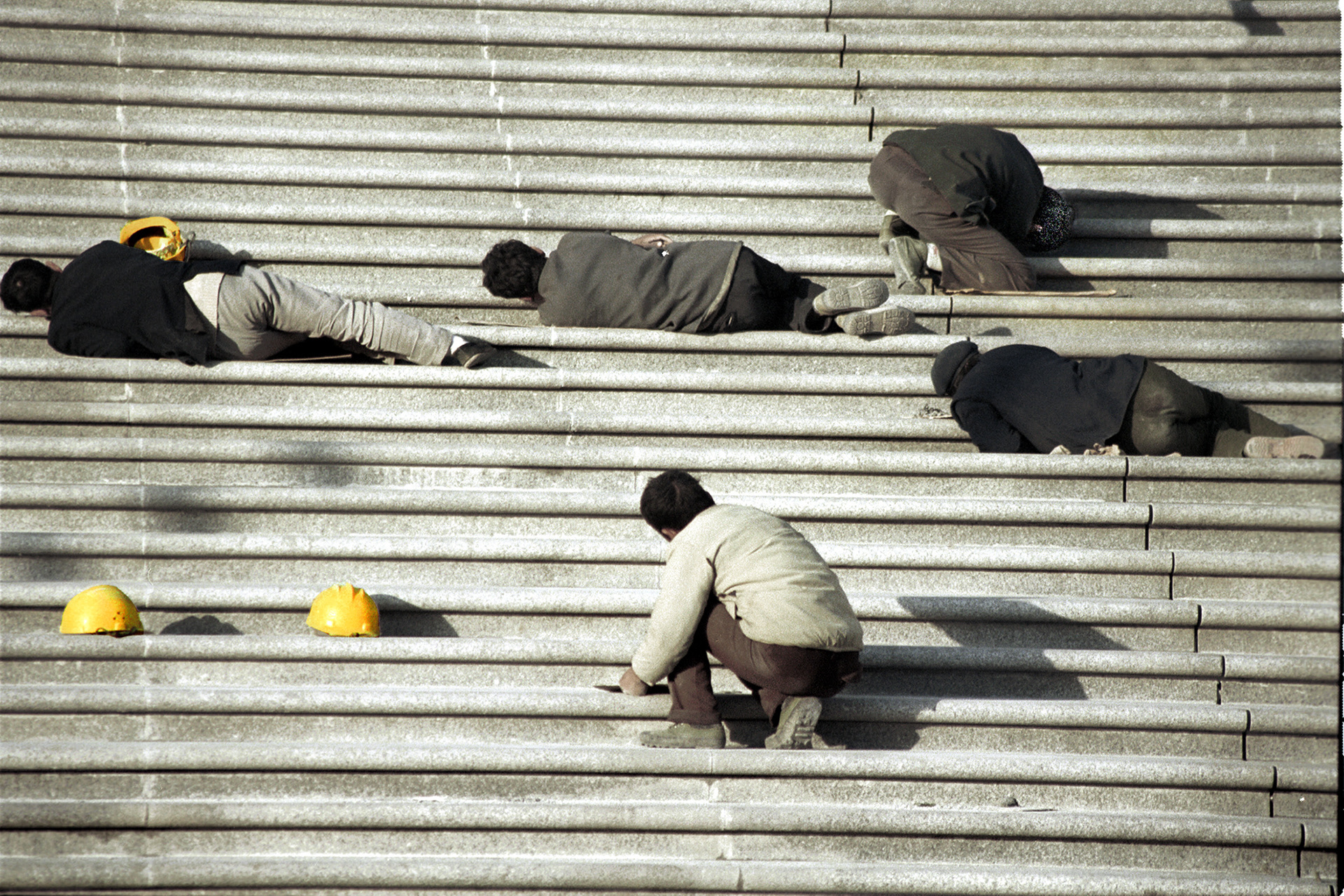 Construction workers completing final work to a new building, Chang'an St, Beijing, China