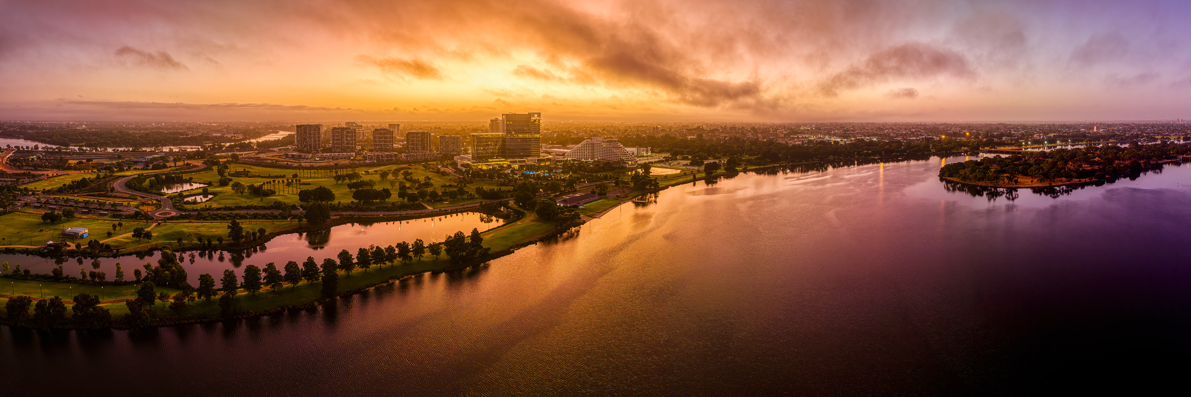 Sunrise drone panorama of Crowne Casino precinct and surrounding parks.