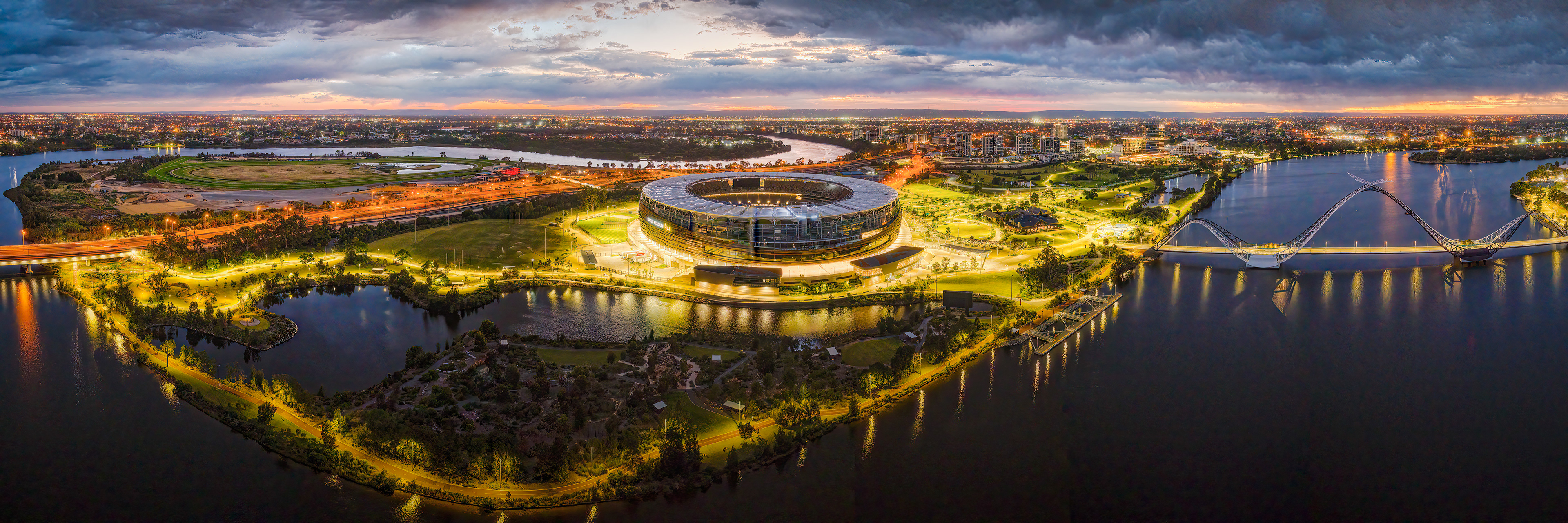 Stormy morning sunrise panorama of Optus Stadium and surrounding parks in East Perth.