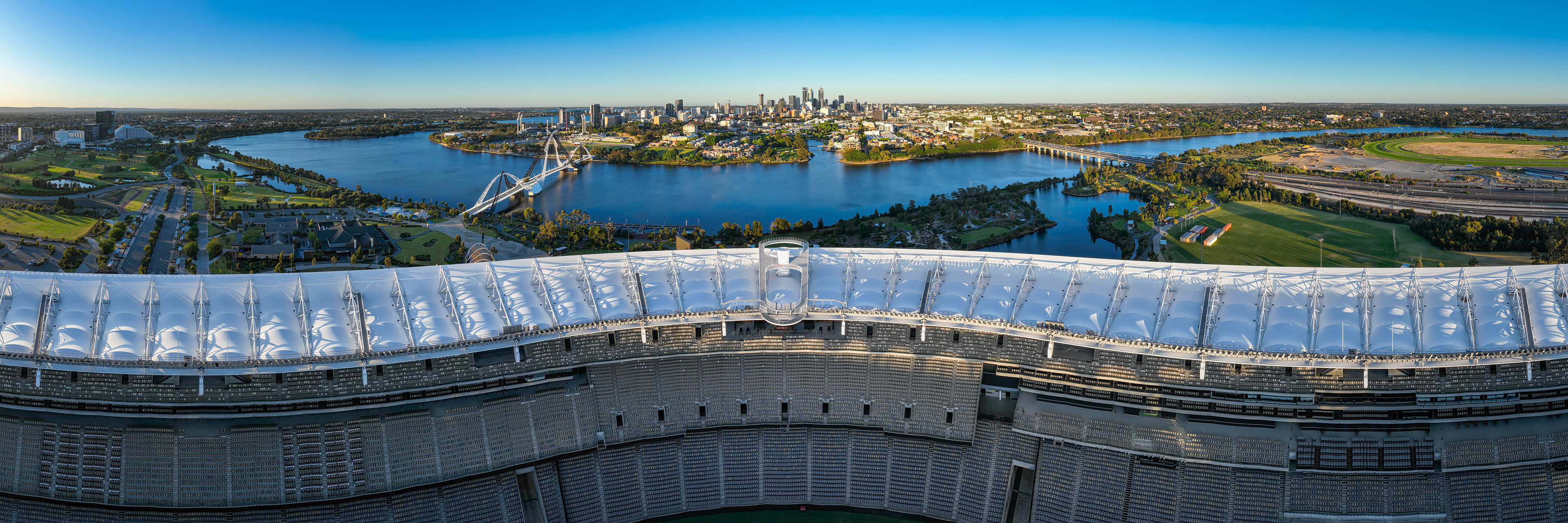 Drone HDR panorama of Perth City, Matagarup Bridge, Windan Bridge, Swan River and the top rim of Optus Stadium spanning across the panorama.