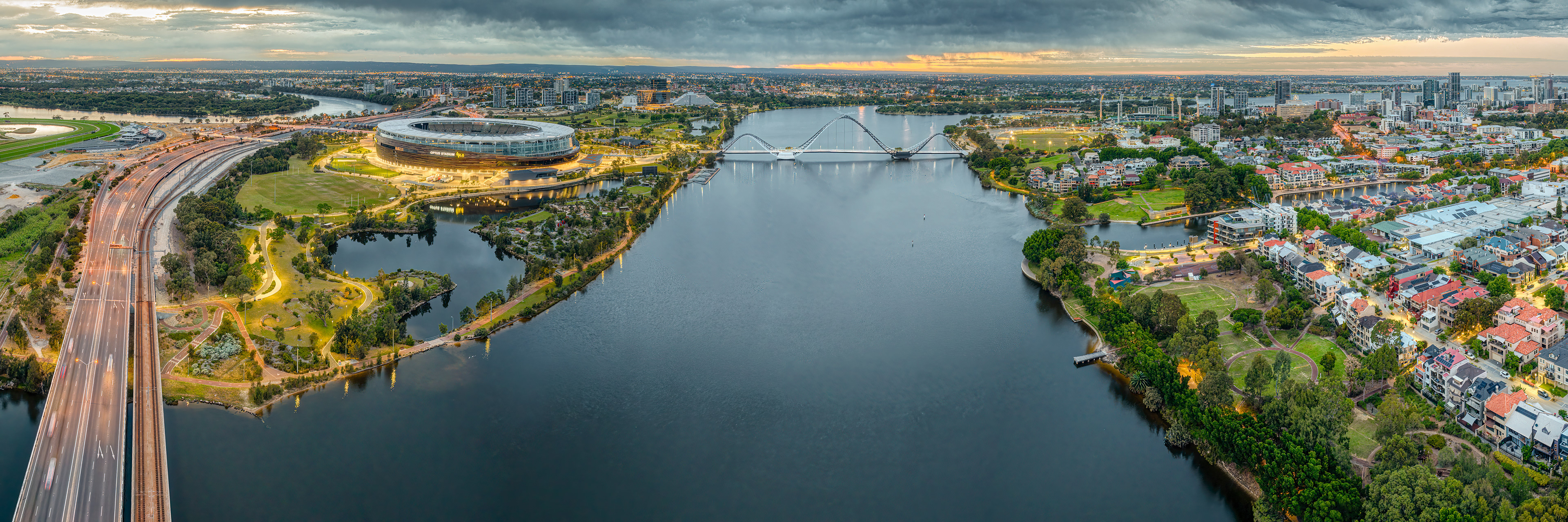 East Perth panorama along the swan river with Graham Farmer freeway to the left, Optus Stadium and then Matagarup Bridge across the Swan River and finally the East Perth precinct to the right of image.