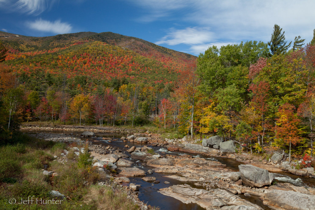 Colorful autumn foliage in the mountains along a rocky river