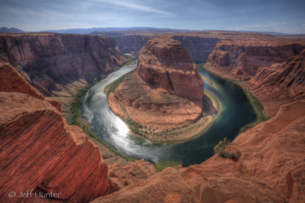 A horseshoe shaped bend in a large river surrounded by rugged landscape