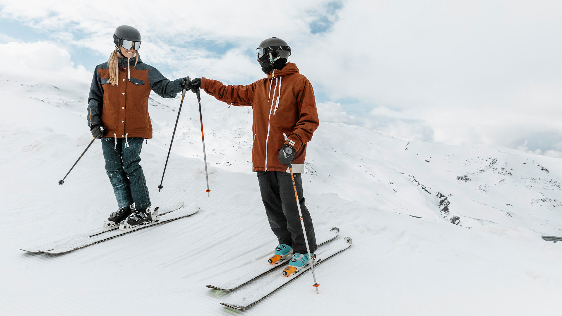Friends reunite, greeting each other after a day of adventure on the slopes, enhanced by the convenience and safety provided by their Alpine Smart Goggles. Music starts to slow down and shot pans up to sky and fades to white.