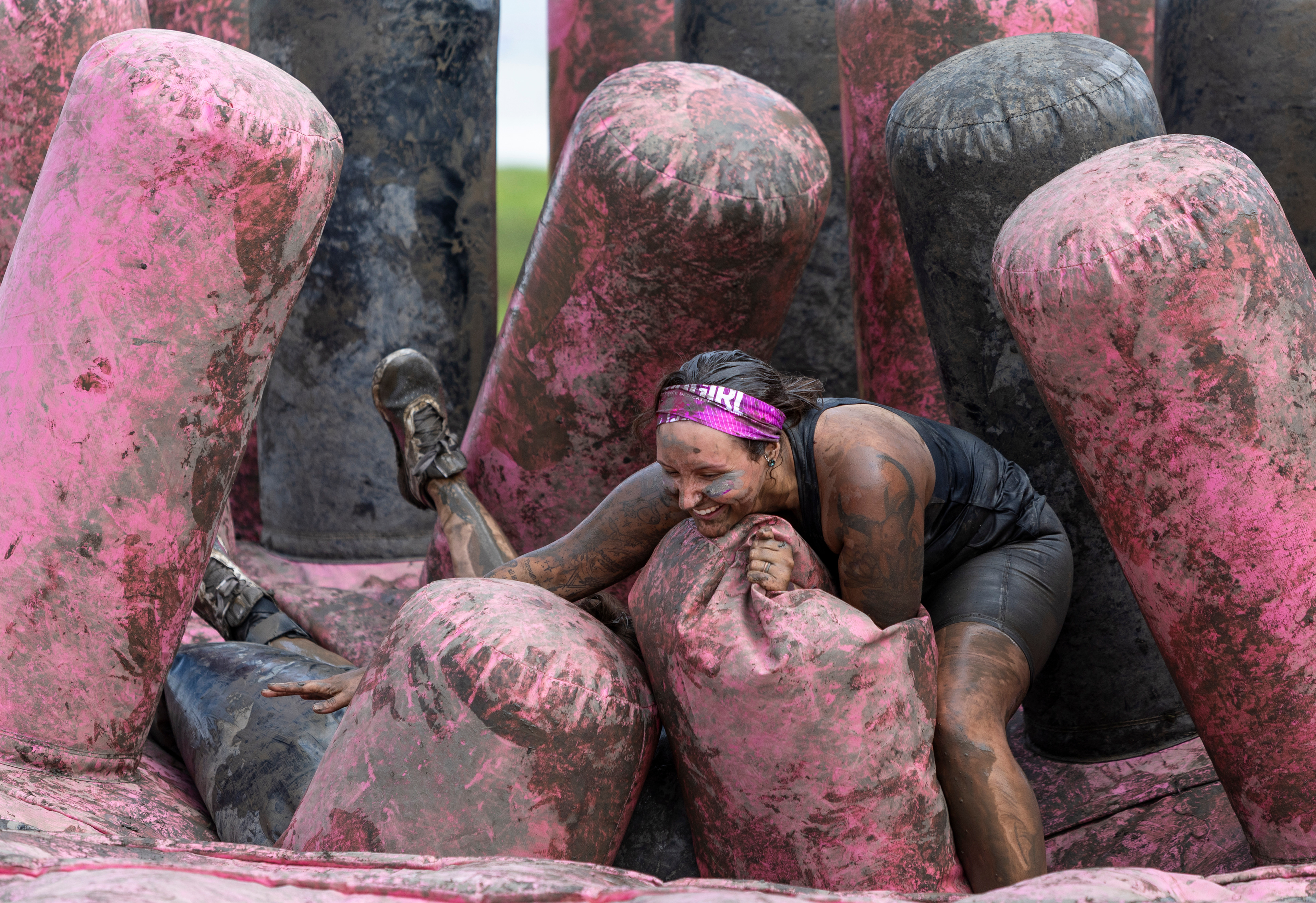 Isabella Joyce of Iowa tries to maintain her balance in an inflatable obstacle during the MudGirl obstacle race in Granite City, Ill. on Saturday, July 20, 2024. (Dominic Di Palermo/St. Louis Post-Dispatch)