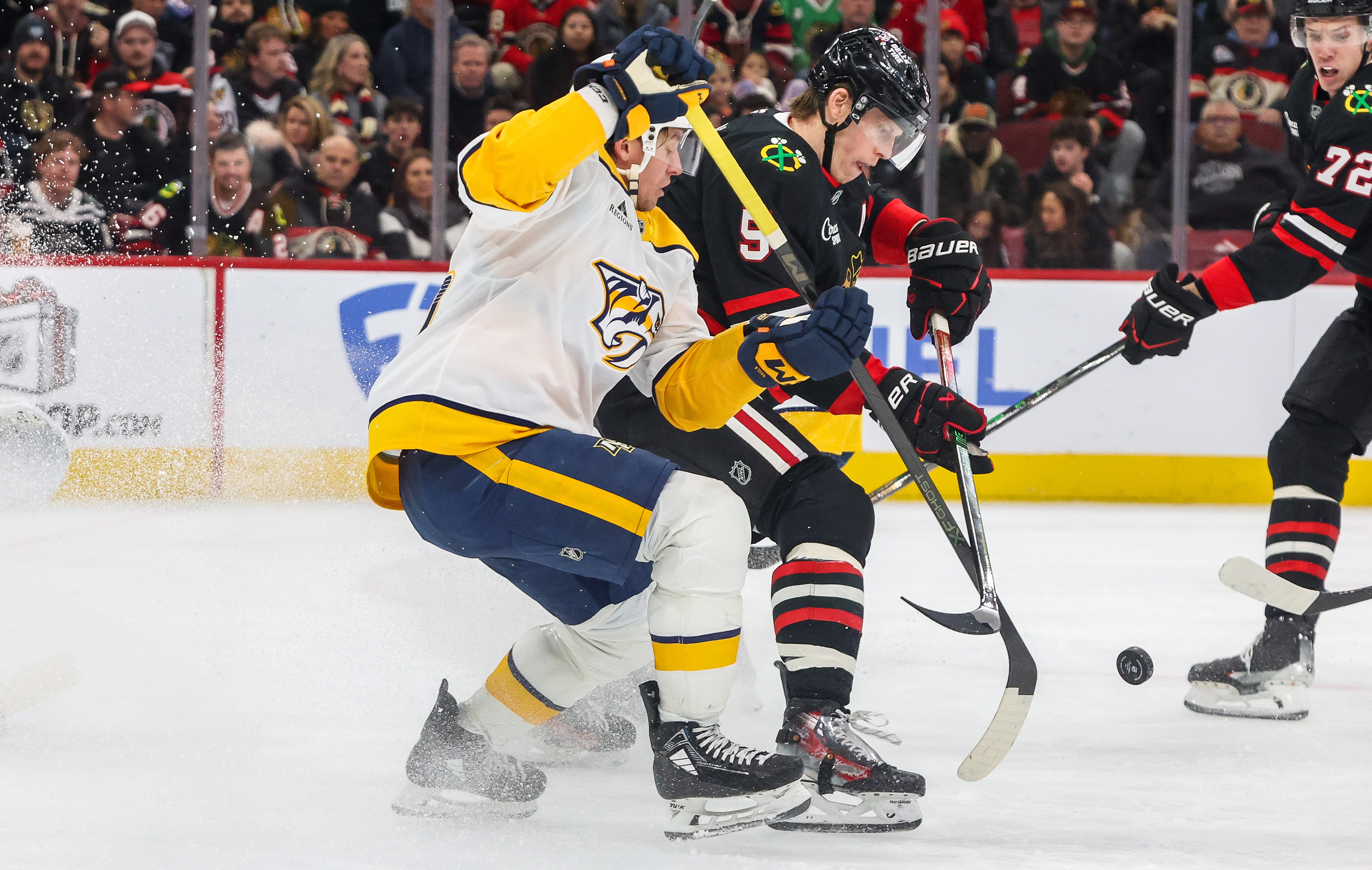 Blackhawks defenseman Connor Murphy (5) and Nashville Predators left wing Erik Haula (56) battle for the puck during the second period, Nov. 28, 2025, at the United Center in Chicago. (Dominic Di Palermo/Chicago Tribune)