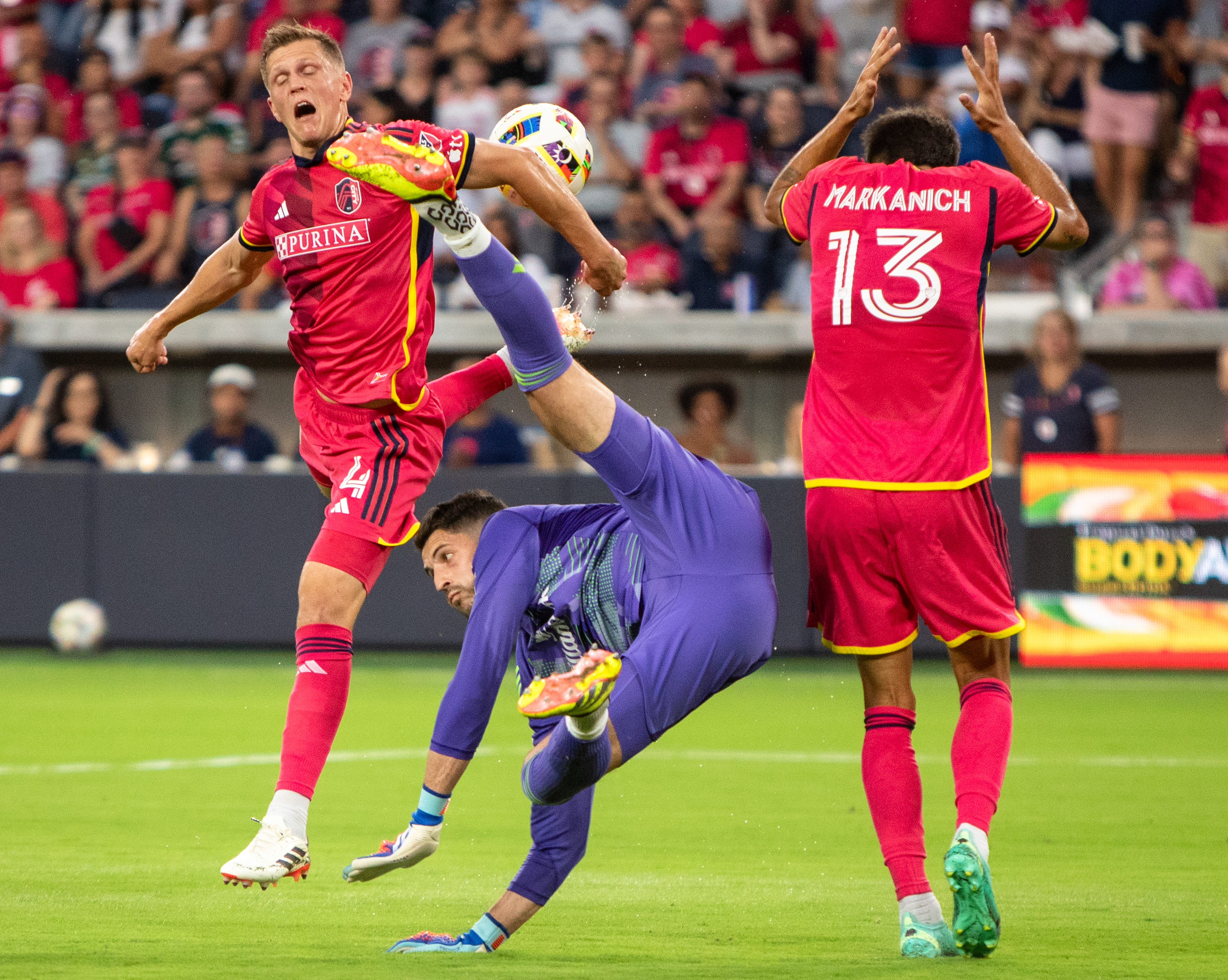Portland Timbers goalkeeper James Pantemis (41), middle, dives past St. Louis City SC’s defender Anthony Markanich (13), right, and defender Joakim Nilsson (4), to save a goal during the first half of a game at CityPark stadium in St. Louis, Mo. The teams tied 0-0. (Dominic Di Palermo/St. Louis Post-Dispatch)) 