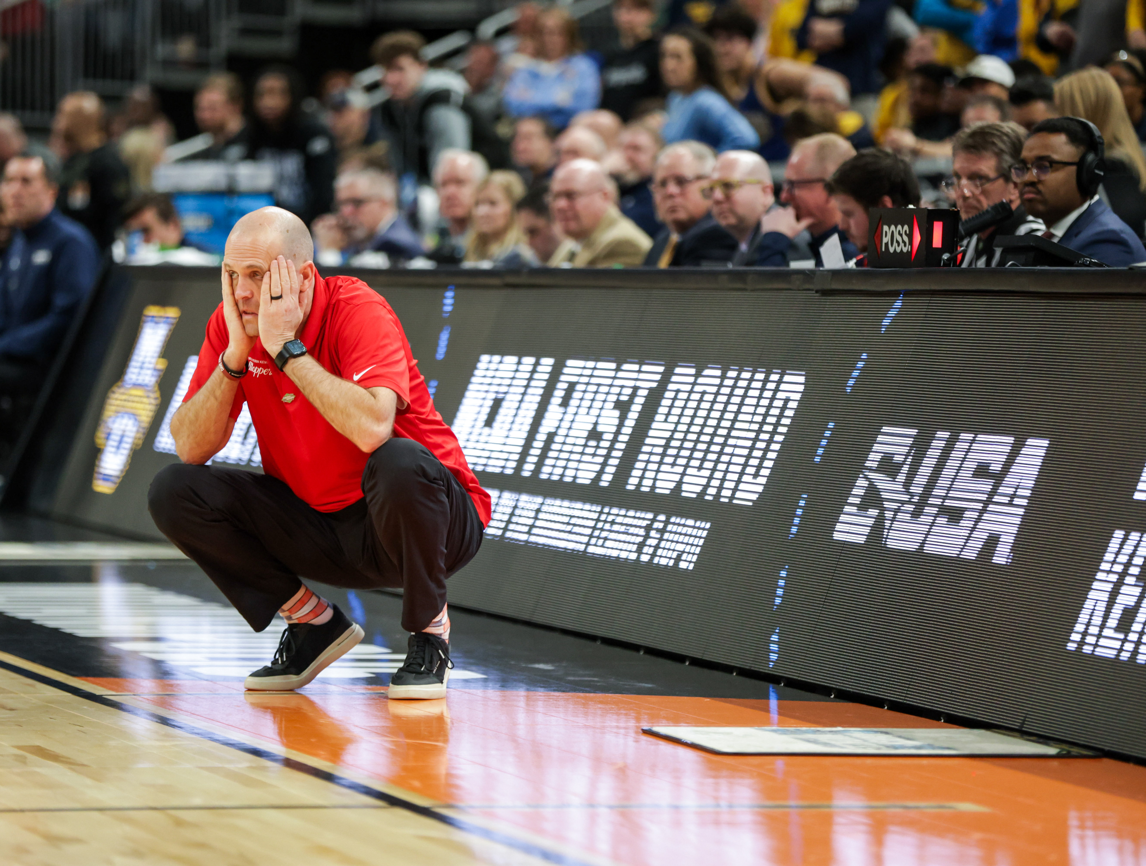  Western Kentucky University Head Coach Steve Lutz puts his head in his hands with minutes left of the second half of WKU’s game against Marquette during the March Madness Round of 64 at the Gainbridge Field house in Indianapolis on Friday, March 22, 2024. Marquette won 87-69 and advanced to the second round of the tournament.