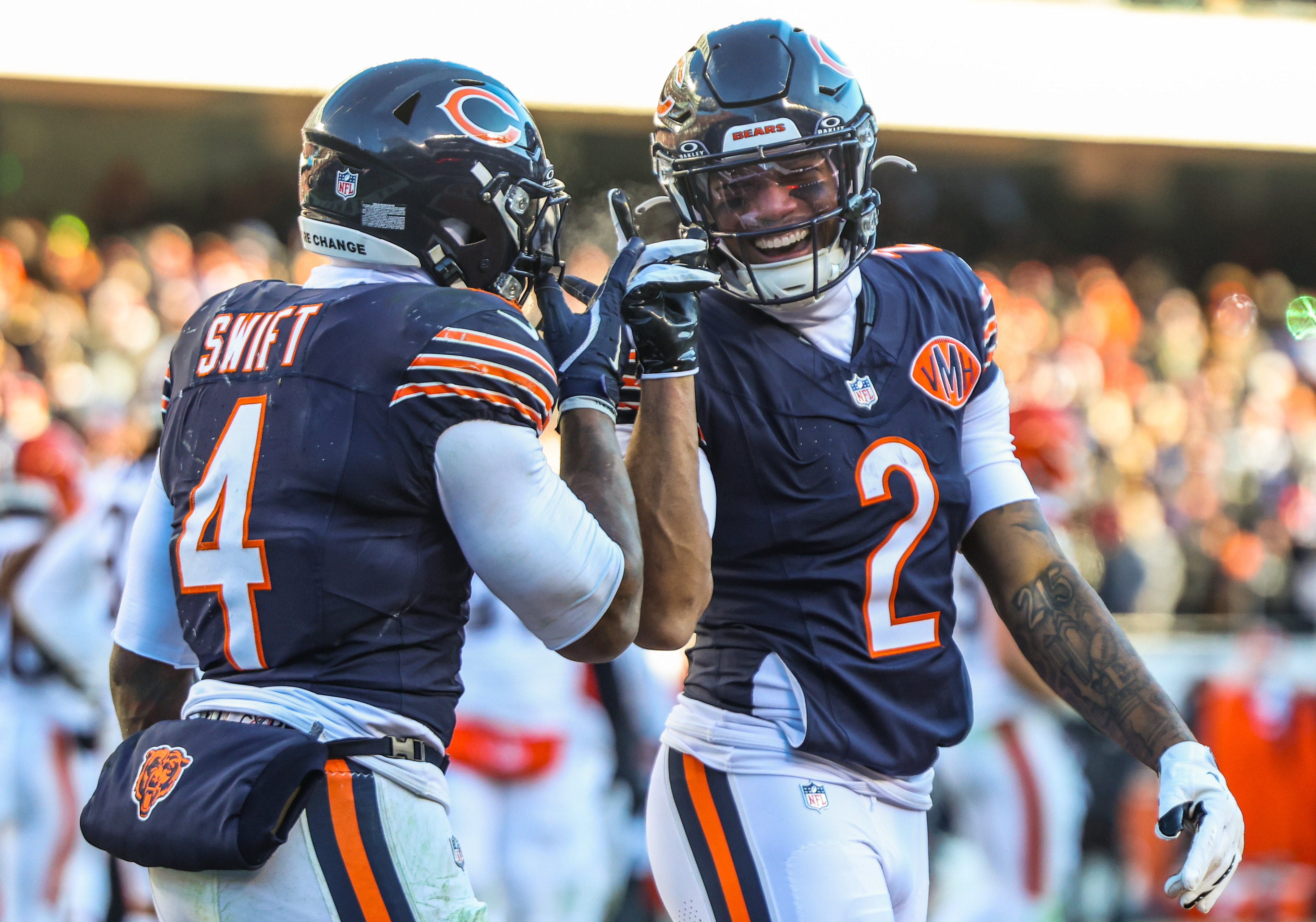 Chicago Bears wide receiver DJ Moore (2) and Chicago Bears running back D'Andre Swift (4) celebrate Swifts touchdown that brought the Bears’ lead to 27-3 during the third quarter against the Browns, Sunday, Dec. 14, 2025, at Soldier Field in Chicago. (Dominic Di Palermo/Chicago Tribune)