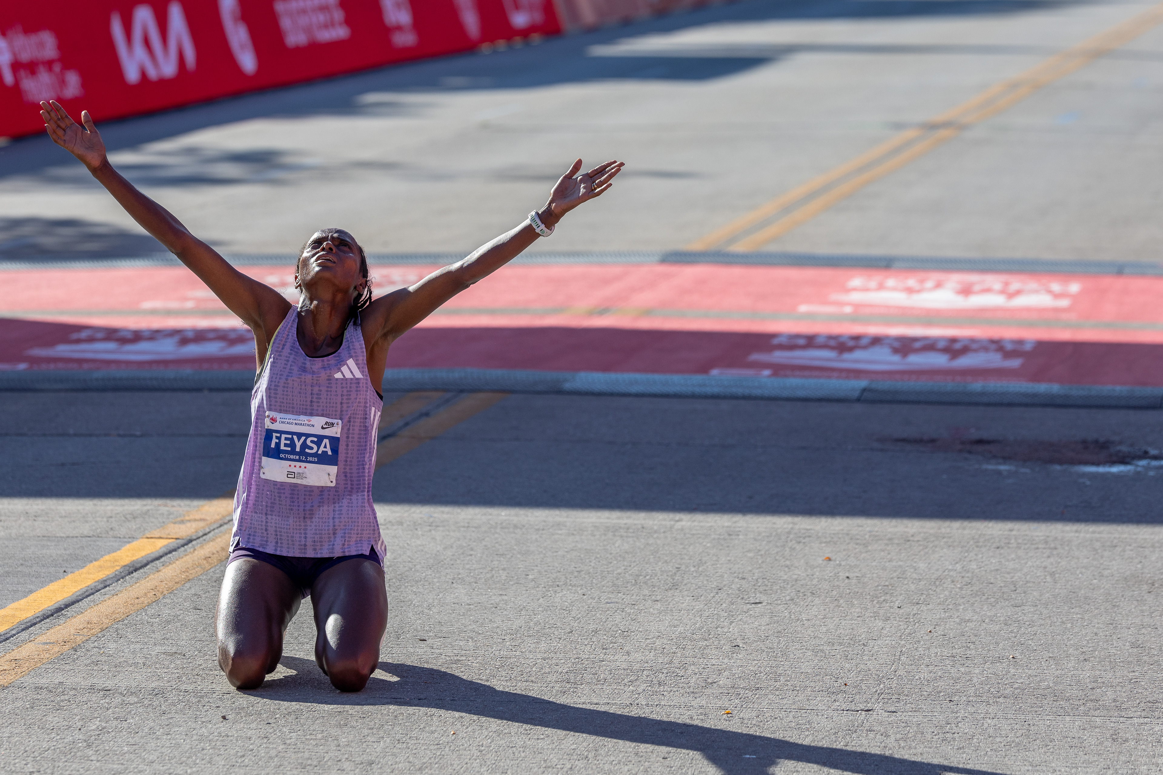 Hawi Feysa, of Ethiopia, prays after crossing the finish line after winning the women’s professional division of the Chicago Marathon in Chicago’s Grant Park on Sunday, Oct. 12, 2025. Feysa finished the race in 2:14:56. (Dominic Di Palermo/Chicago Tribune)