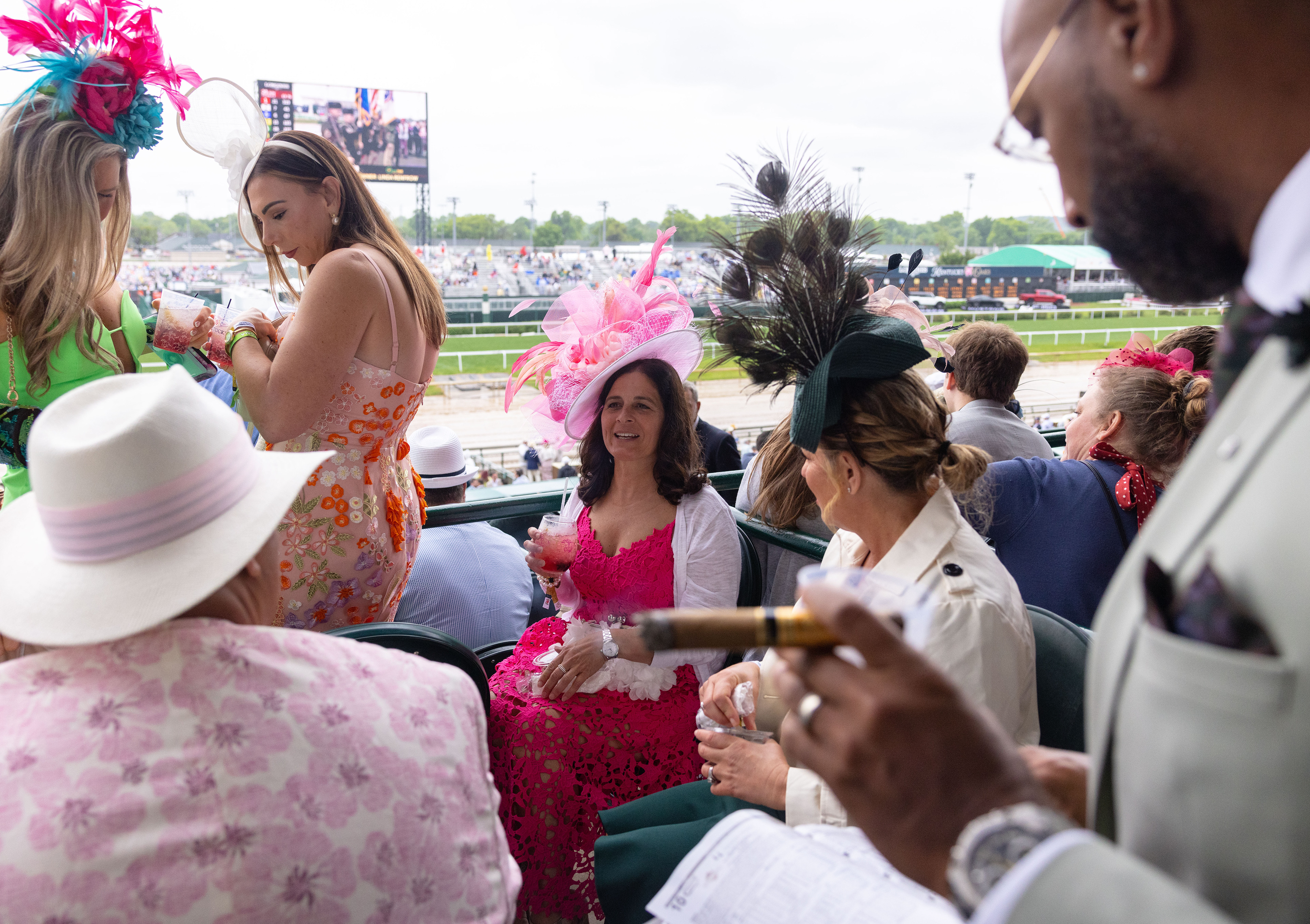 Kristi Contris of Ohio, middle, talks to her friends in the 2nd floor clubhouse seats on the day of the 151st running of the Kentucky Derby horse race at Churchill Downs in Louisville, Ky. on Saturday, May 3, 2025.