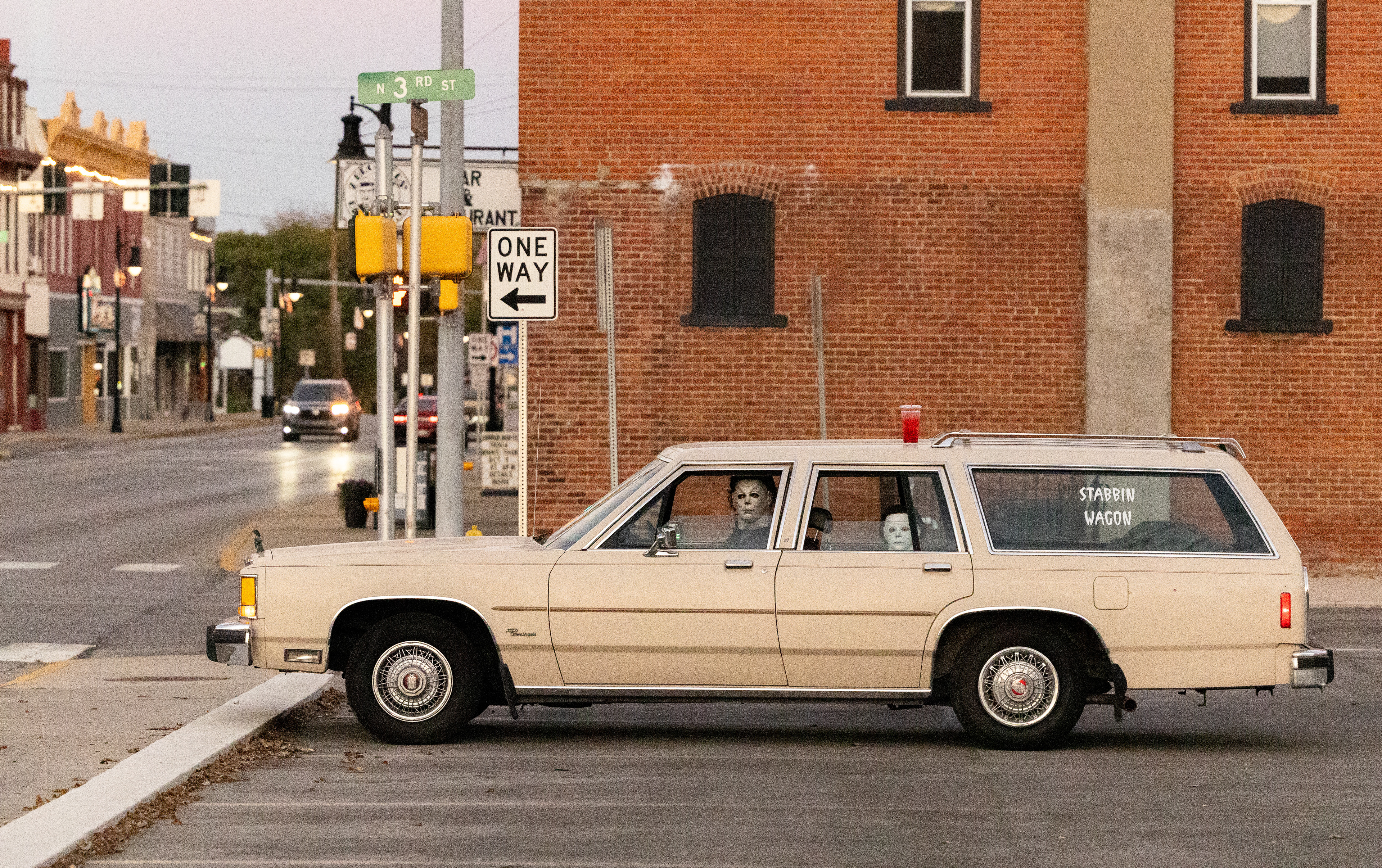 Evan Zimmerman, left, and his son Harrison Zimmerman, 7, prepare to get dinner in their Ford station wagon, similar to the one Michael Myers drives in the movie Halloween. The father-son duo were cosplaying at a horror movie trivia night at D-Town Energy in Decatur, Indiana. The Zimmermans are popular on Tik Tok for dressing as Michael Myers for videos.They are known well in Decatur and often make appearances for meet-and-greets at local venues. (Dominic Di Palermo/Chicago Tribune)