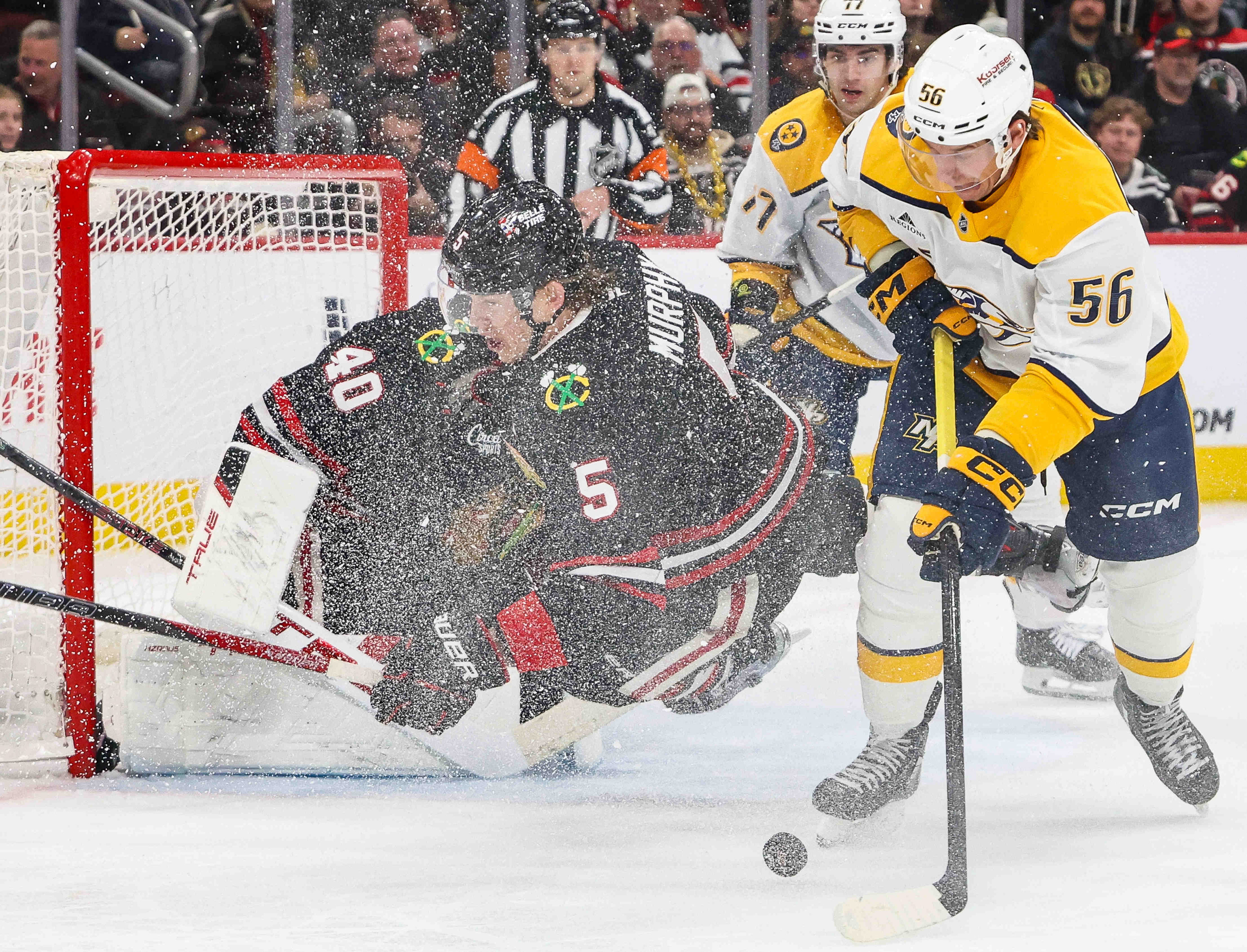 Blackhawks defenseman Connor Murphy (5) and Nashville Predators left wing Erik Haula (56) battle for the puck during the second period, Nov. 28, 2025, at the United Center. (Dominic Di Palermo/Chicago Tribune)