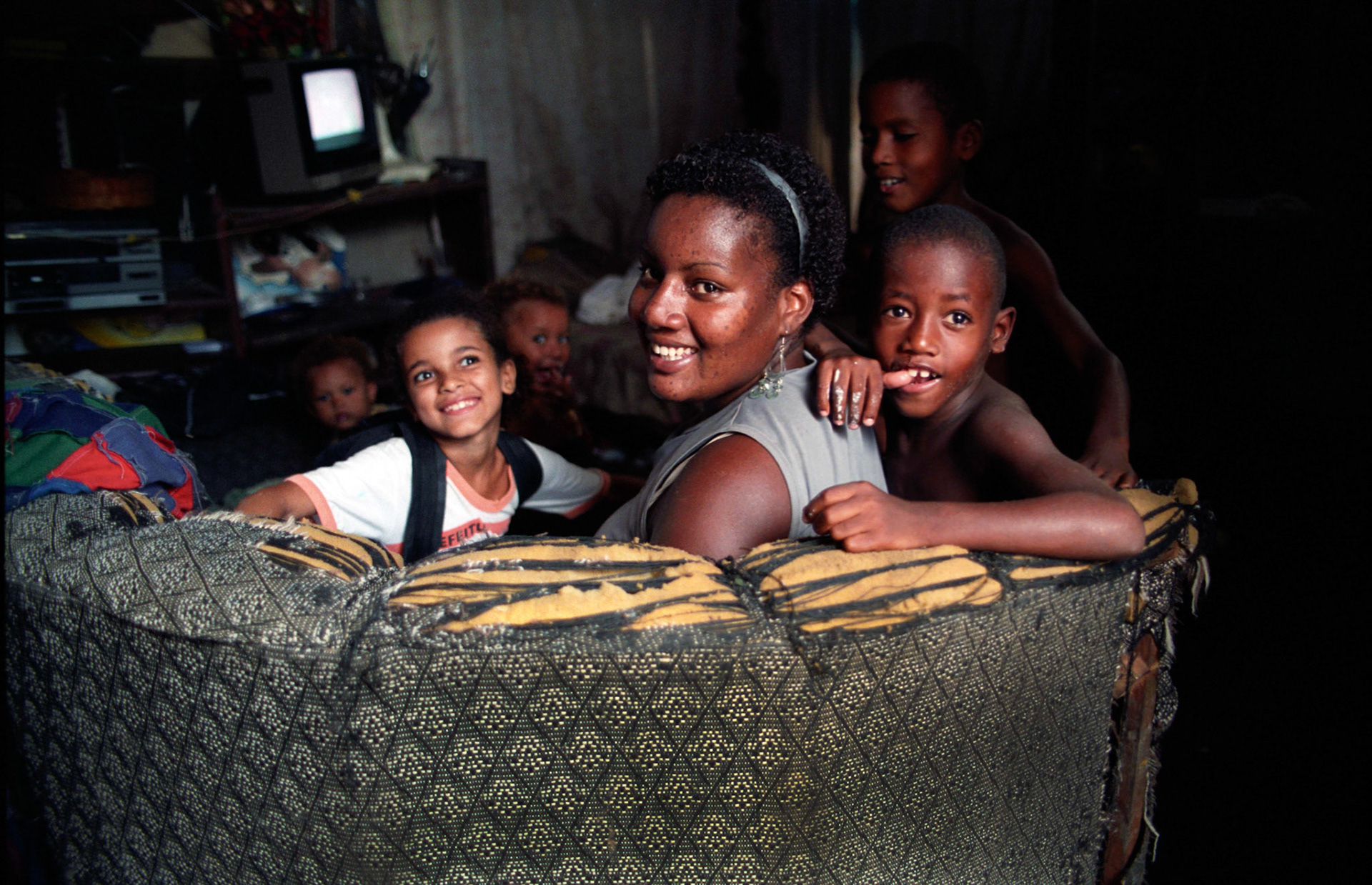 Lucilene and her children in their hut at Terra Encantada, Rio de Janeiro, Brazil.