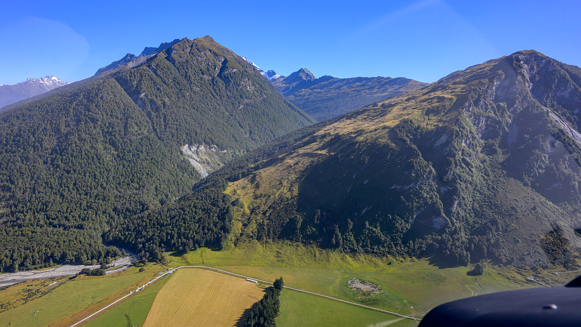 Cars are parked at the entrance to the valley from the hikers and tenters exploring the Earnslaw Burn..