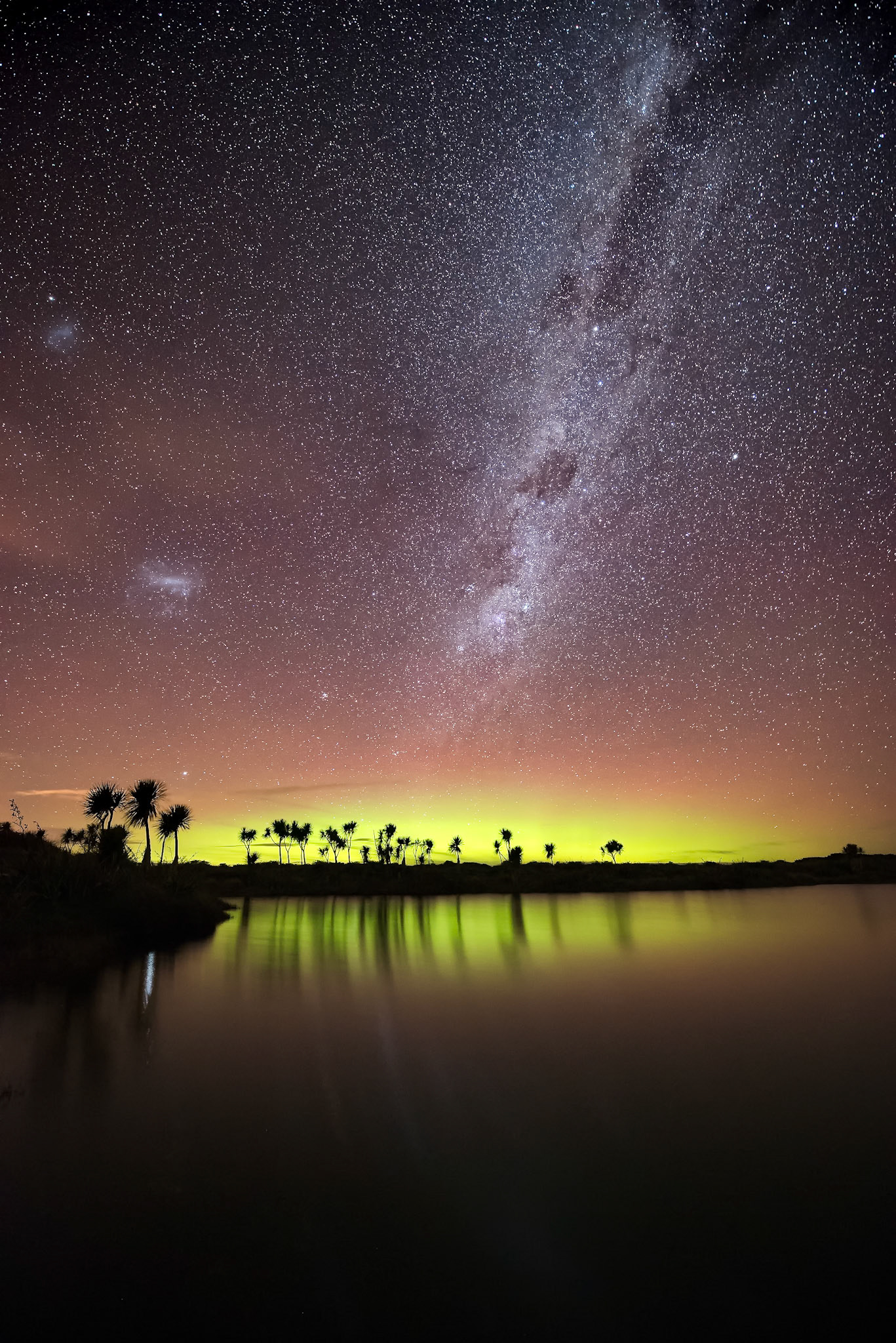 The Milky Way shines high above a subtle Aurora Australis on the horizon, Invercargill