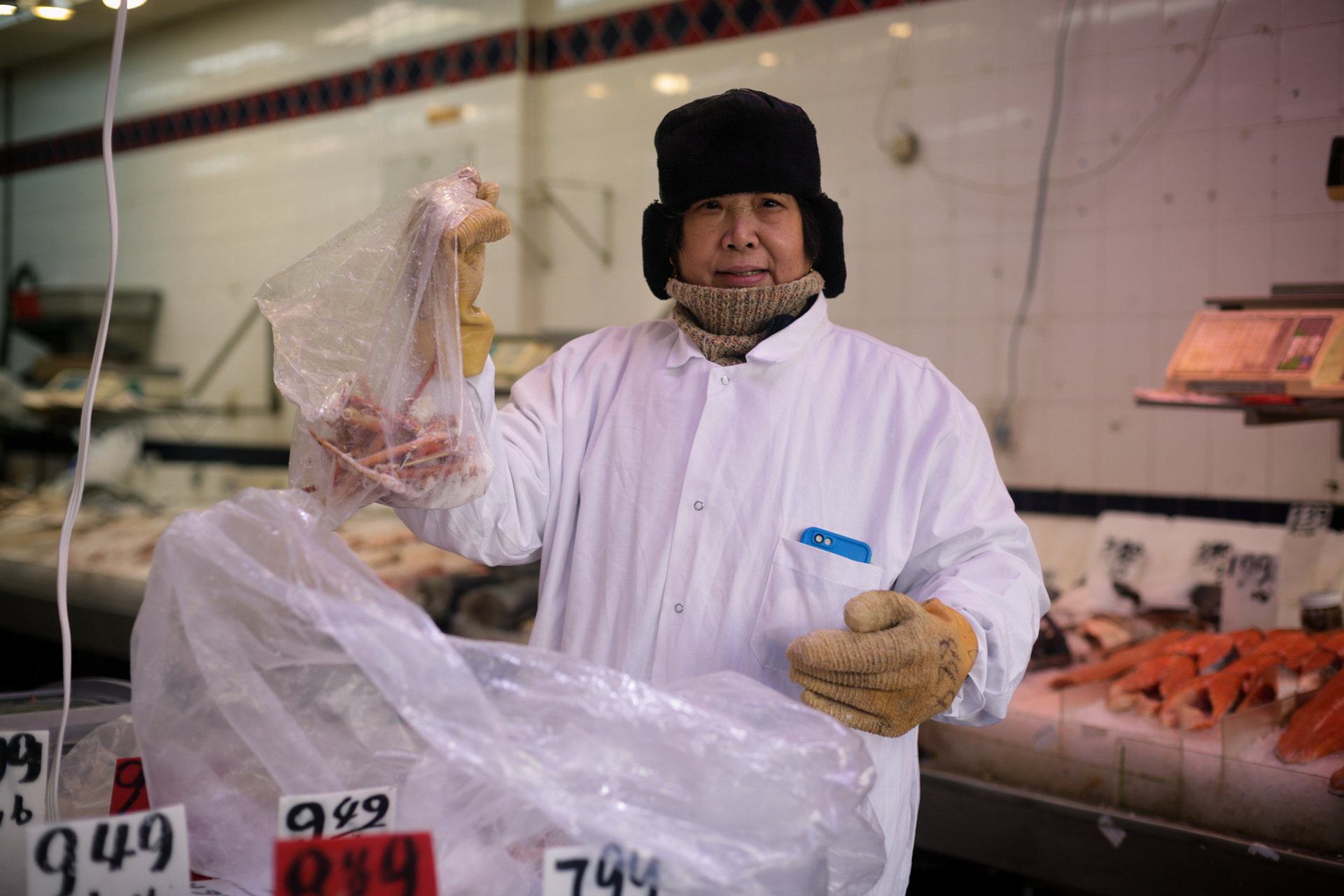 walker street // the shopowner holds crab legs during NYC winter
