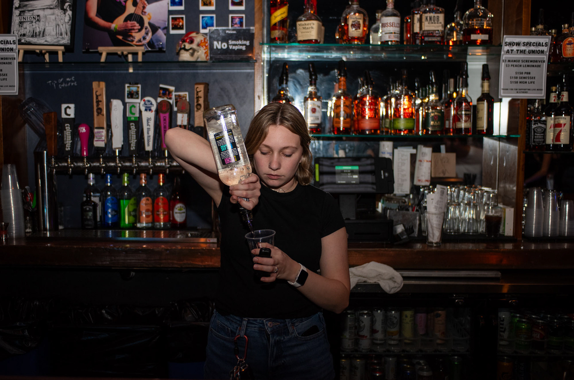 Bartender, Kailey Klimkowski, pouring a drink for a customer at the upstairs bar located at The Union, in Athens, Ohio, Sept. 29, 2023. Although Klimkowski has worked at The Union for about a year now, the environment is what made her want to work there. “I like the vibe of the bar and the great coworkers,” Klimskowski said. “The bar is not a freshman bar environment; it seems like it is mostly graduate students or older people.”