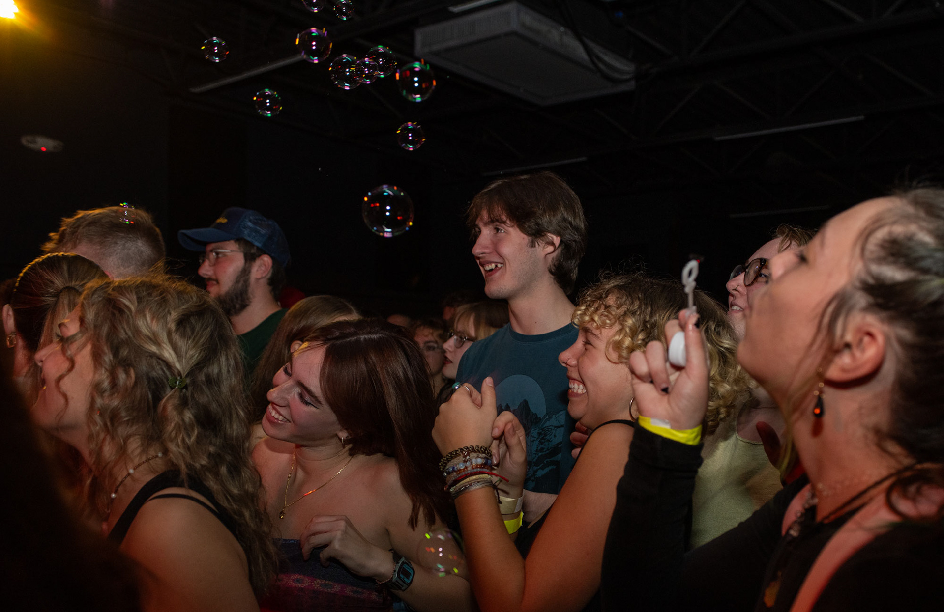 The crowd enjoys the music and dances while another audience member blows bubbles during the band performance, Split, at the upstairs bar in The Union, in Athens, Ohio, Sept. 30, 2023. Despite The Union being 18+ the environment of the bar is friendly, compared to the bars in Athens that are 21+.