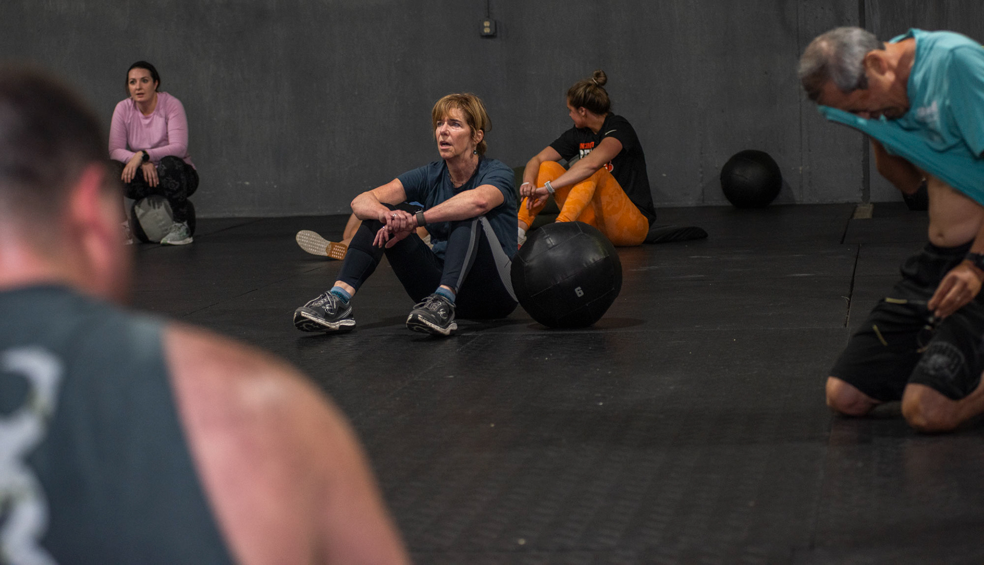 Members of CrossFit SEO exhausted after their workout at CrossFit SEO, in Athens, Ohio, Dec. 2, 2023.