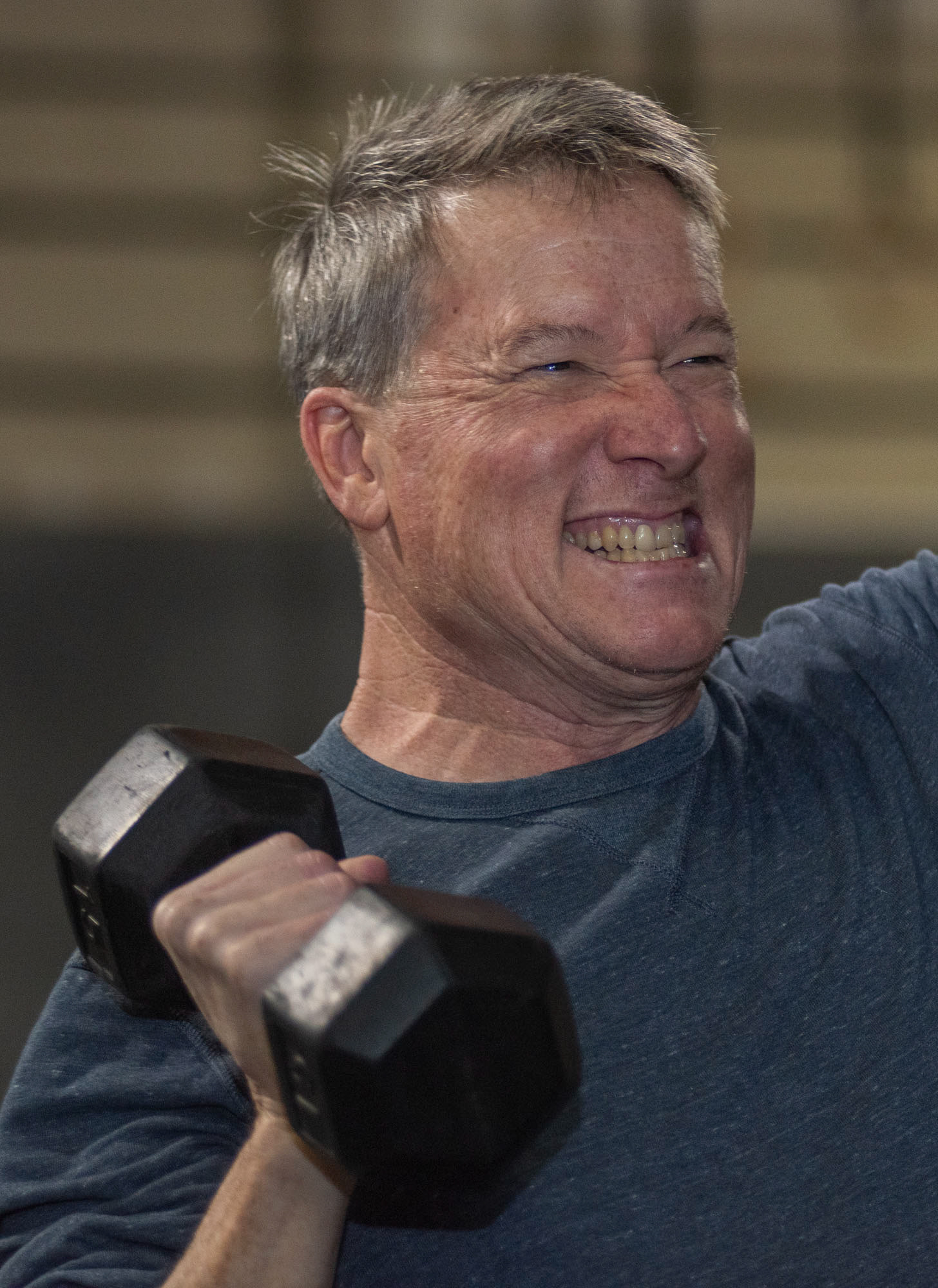 Jody Grenert, lifting dumbbells during group class at CrossFit SEO, in Athens, Ohio, Nov. 18, 2023. Grenert has been coming to CrossFit SEO, because he needed core strength since he does yard work a lot. “I have noticed that I don’t have any more problems, and I have been coming here for two years,” Grenert said.