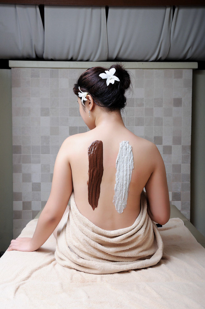 Body scrub process using ointment, herbs and spices in spa treatment.