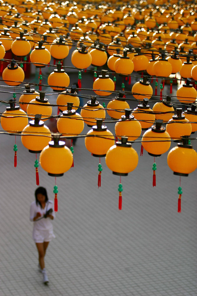 KUALA LUMPUR, MALAYSIA - MAY 2011Girl passing by thousands of lantern at Lantern Festival during the Wesak day at Kuala Seputih Temple in Kuala Lumpur May 17, 2011.