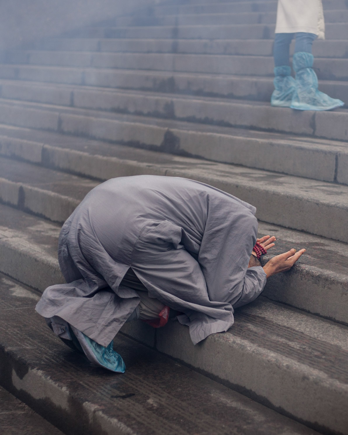 Monk bowing on steps