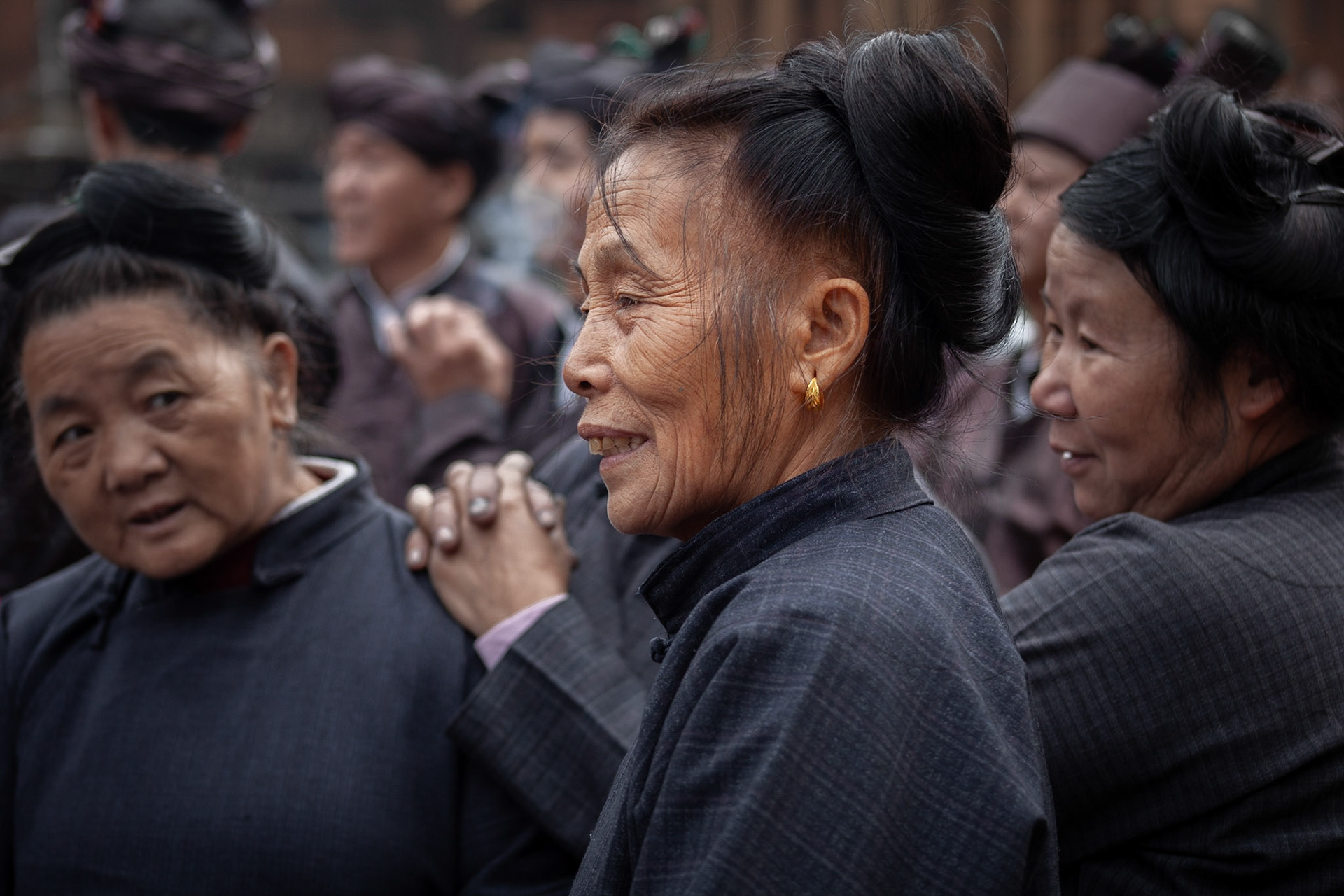 Three Elder Dong Women watching folk song competition