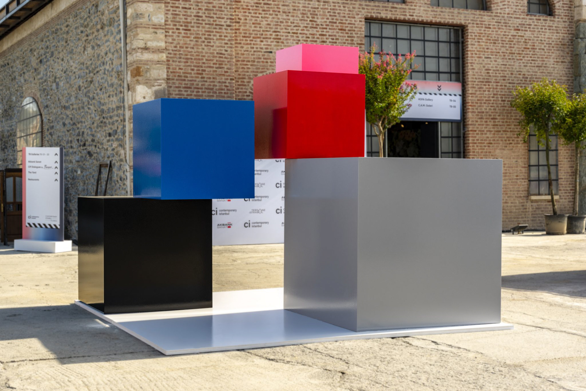 "Colorful sculptural cubes installed outdoors at Contemporary Istanbul 2022, representing wall color data from Sanatorium exhibitions."