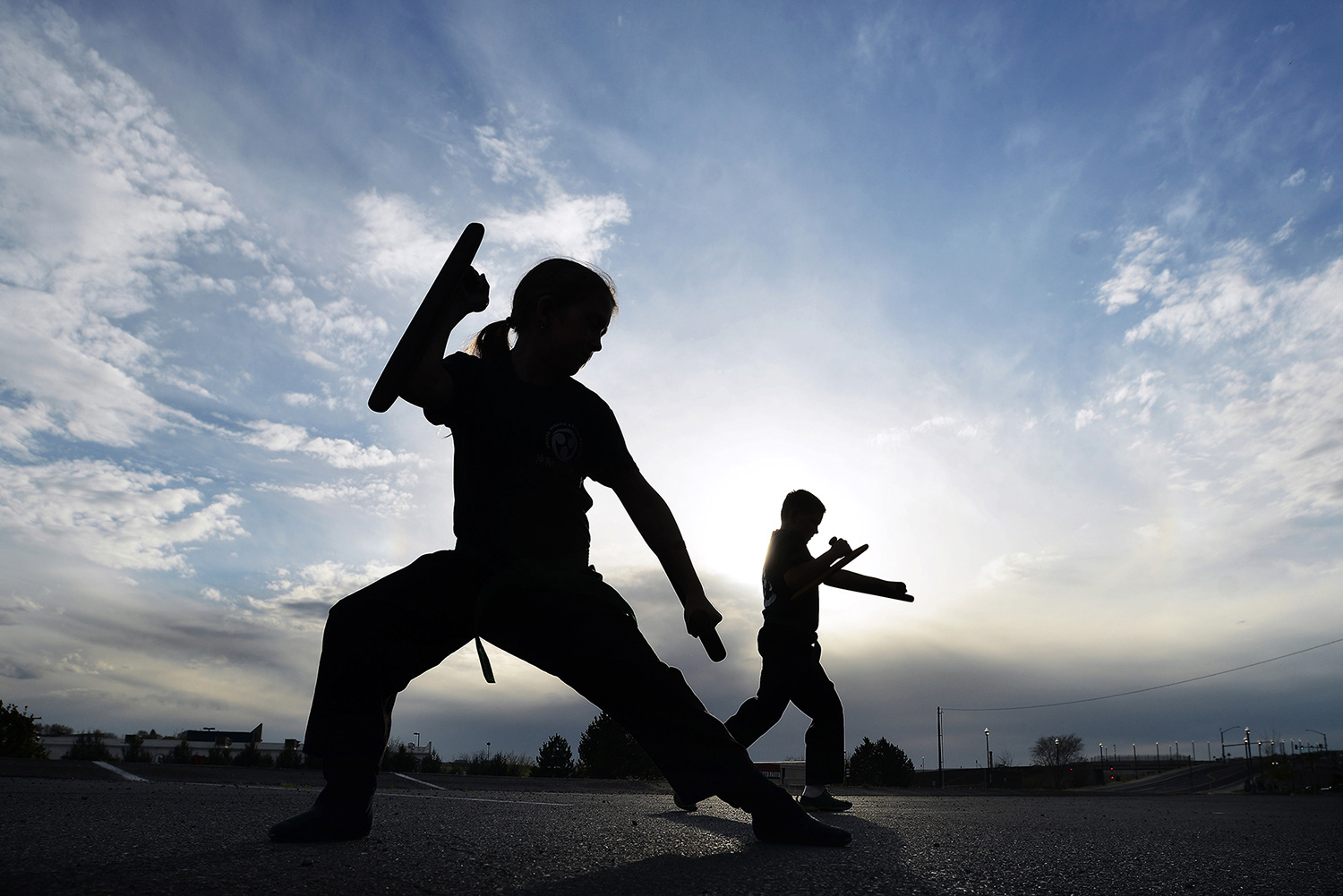 A pair of karate students, whose parents did not wish them to be identified, practice their form using tonfa on Monday, April 15, 2015, outside the Daishu Kan Karate School in Pendleton. The tonfa is a traditional Okinawan melee weapon that derives from a millstone handle and was developed in medieval Japan as a way for peasants to protect themselves.