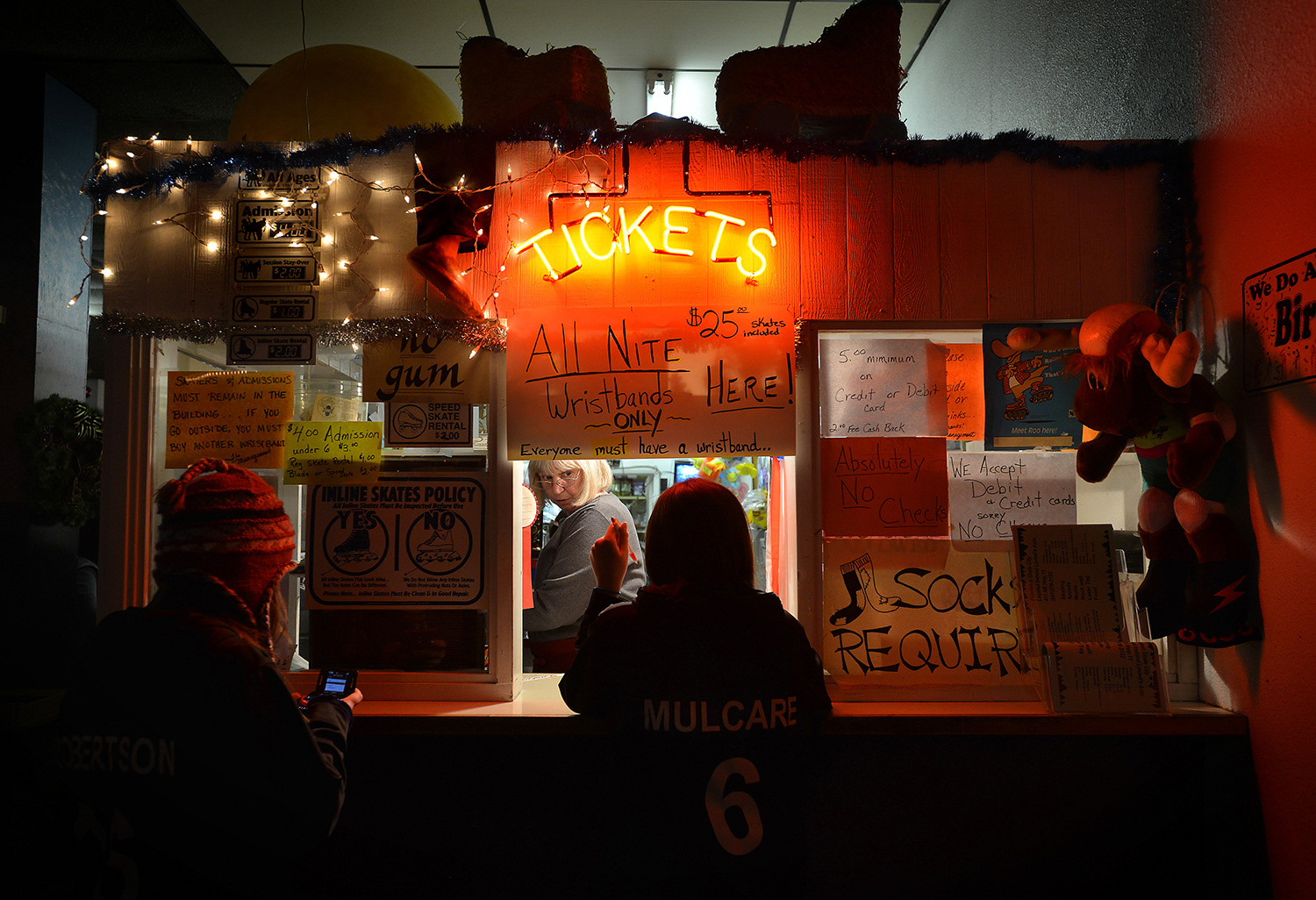 Manager Lorraine White helps a customer from the ticket booth Monday, Dec. 31, 2012, at the Pendleton Skate City roller rink in Pendleton, Oregon.
