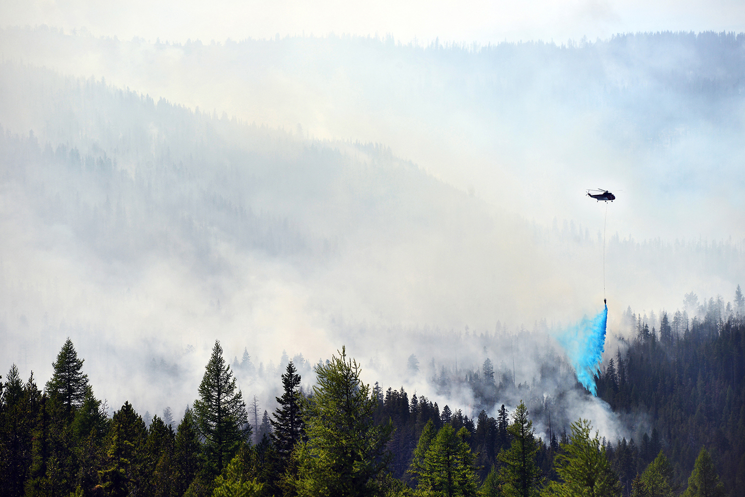 A helicopter drops a load of Thermo-Gel on the leading edge of the 970-acre Vinegar Fire on Tuesday, August 20, 2013, in the Greenhorn Unit of the North Folk John Day Wilderness Area southwest of Granite, Oregon.