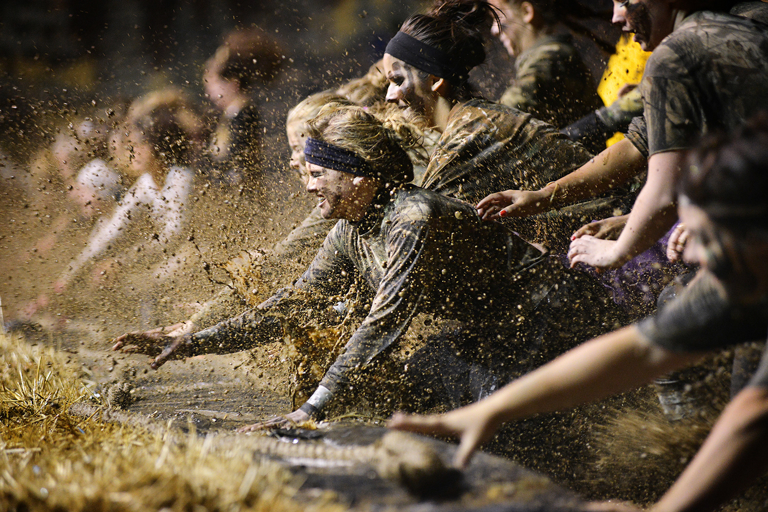 Freshman Emily May, center, reaches for the rope during a tug-of-war between her teammates, the Camo Killers, and the Animal Prints team on Wednesday, Oct. 10, 2012, during the Pendleton High School Mud Wars at the Happy Canyon Arena in Pendleton, Oregon.\