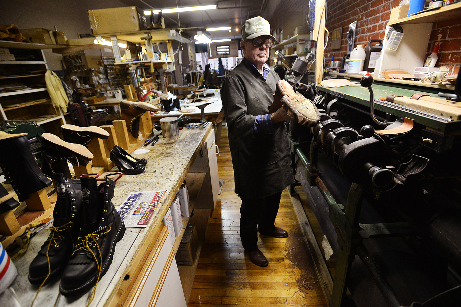 George Ziermann, owner of George's Handmade Boots-Shoe Repair, inspects his handiwork while making a pair of boots Tuesday, Jan. 8, 2013, at his shop on Main Street in Pendleton, Oregon.