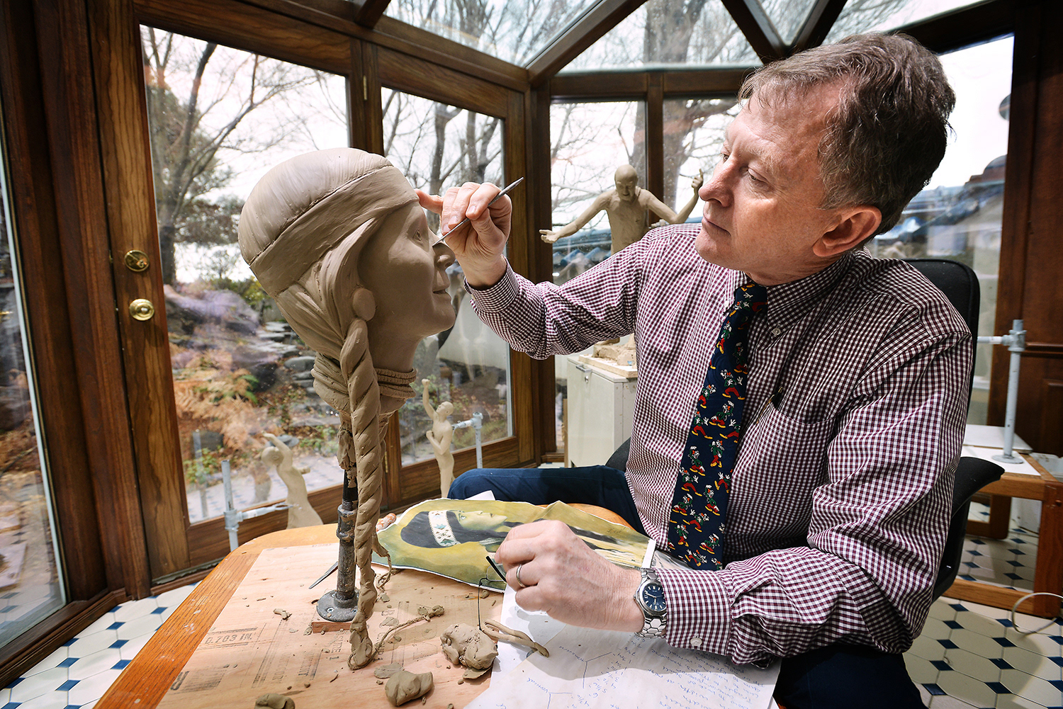Dr. Steven Neal works on the head of clay sculpture of Esther Motanic in his studio Monday, Jan. 7, 2013, at his home in Pendleton, Oregon. The head, along with the rest of the body, will be cast in bronze for a statue the city of Pendleton has commissioned and will be placed on the east side of town.
