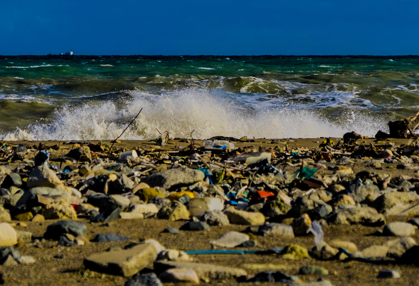 Black Sea coast east of Yeniköy: flotsam, stones, sea and a ship