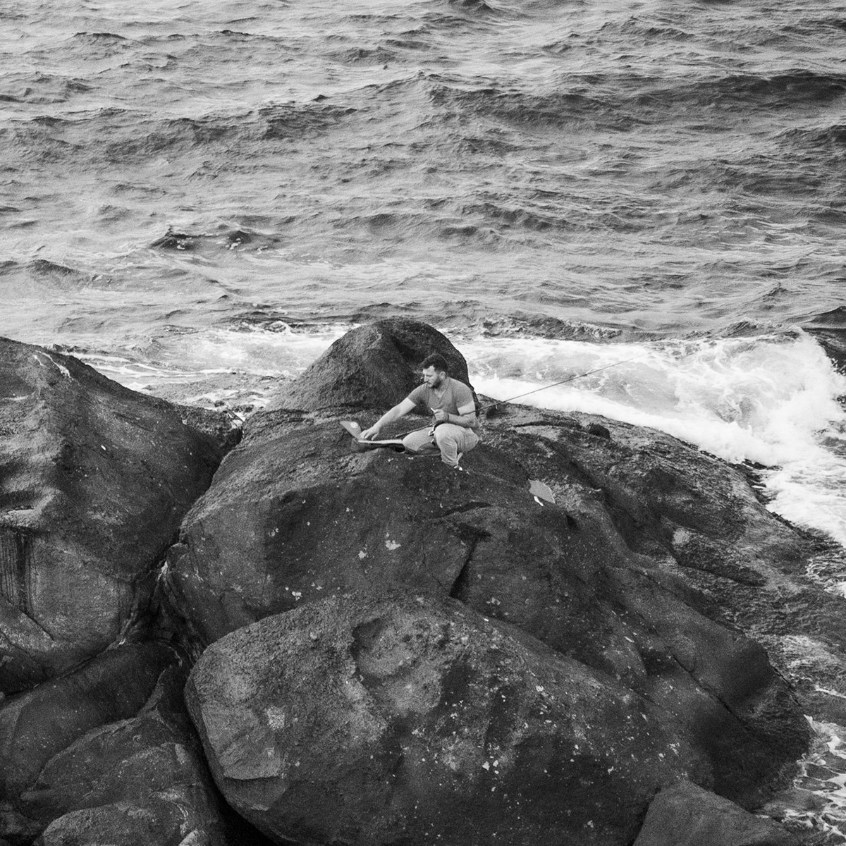 between the English Houses and Riva: fisher on the rocks