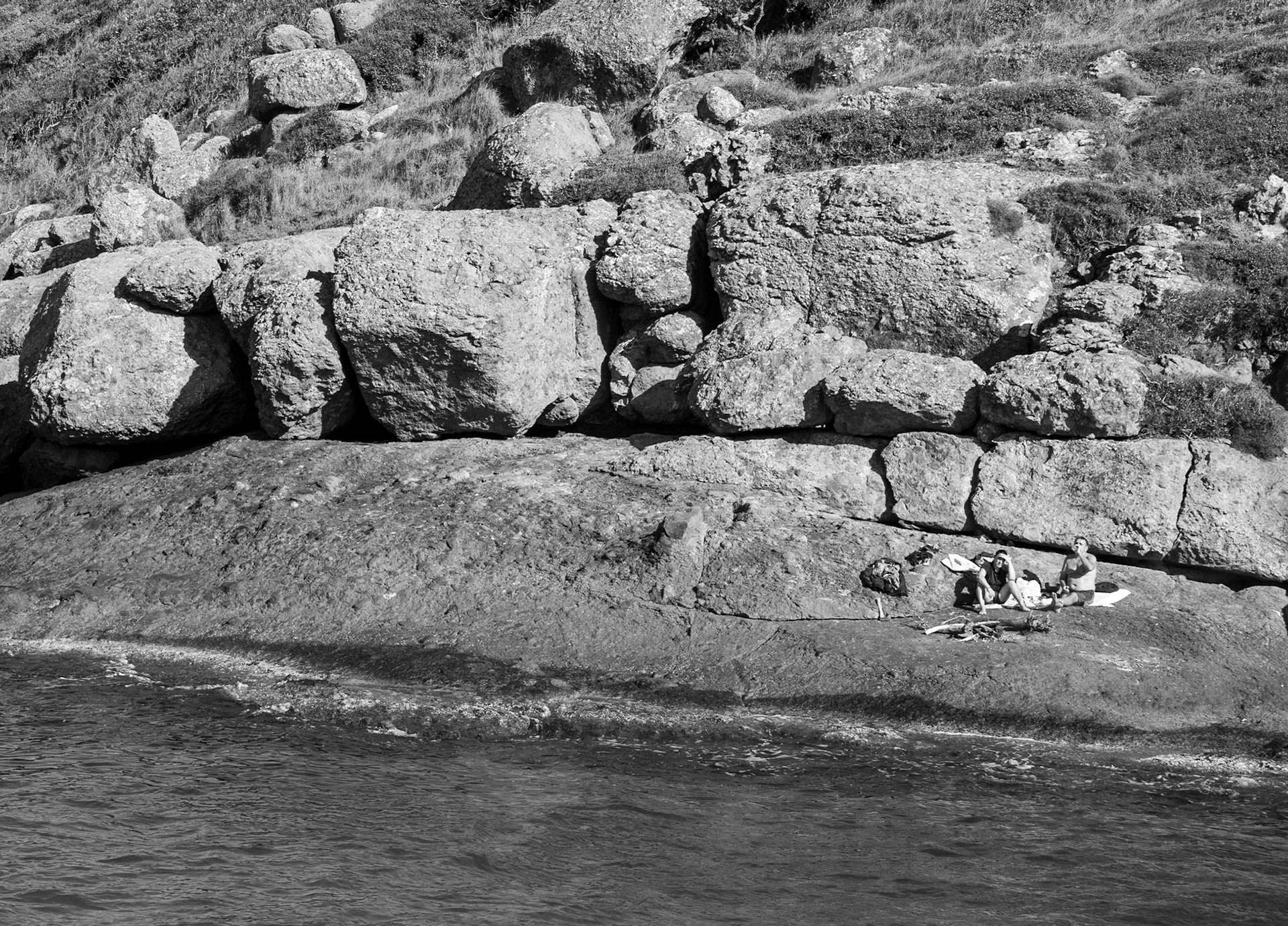 heading west along the line of the Black Sea: sunbathing men on a headland