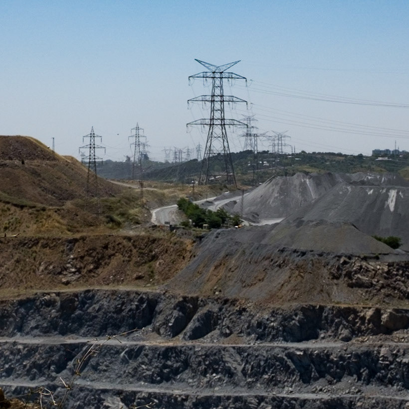 Alibey mines: looking into one of the pits together with pylons marching along the top