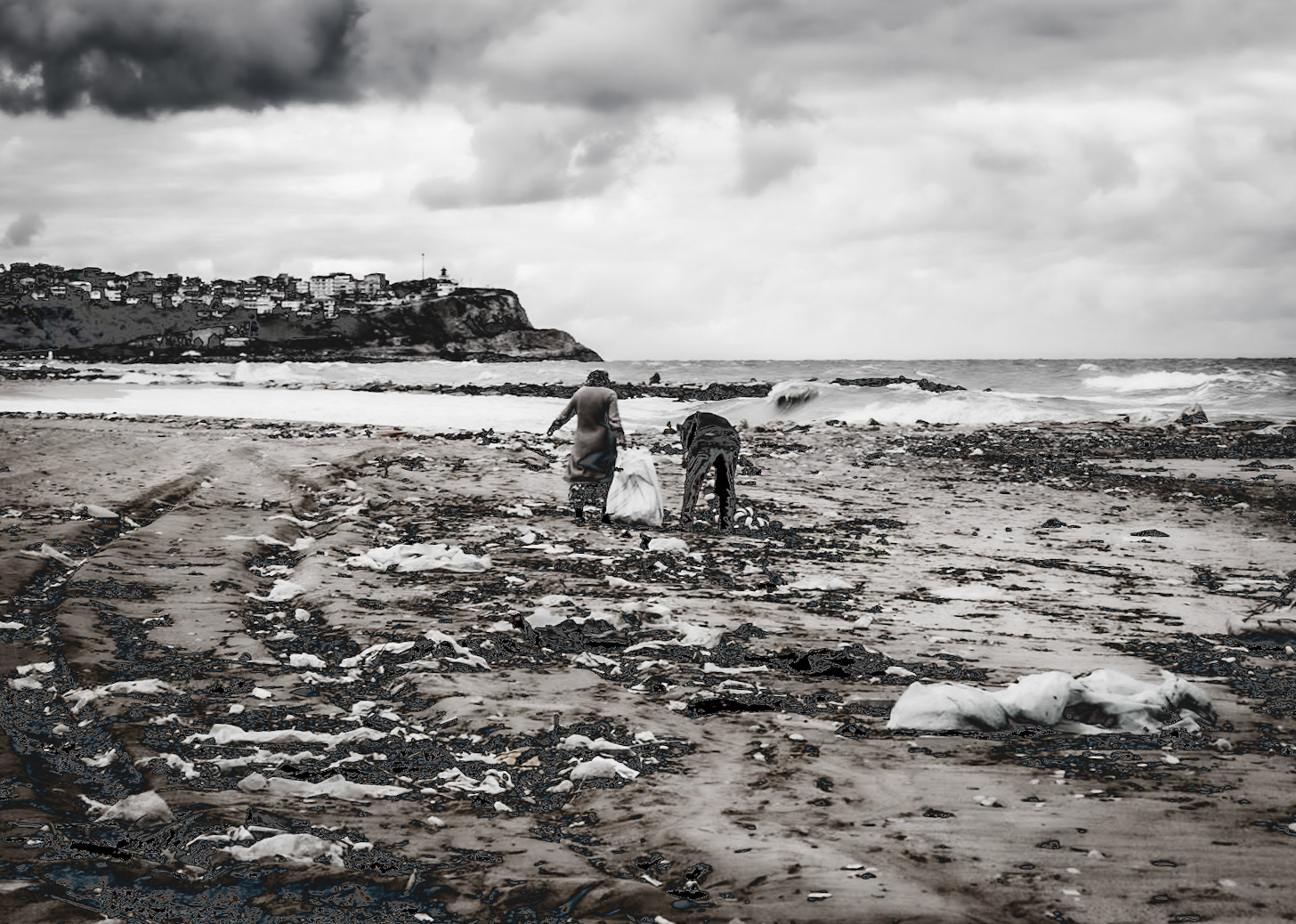 Karaburun beach: a friendly, elderly couple collecting driftwood for their home fire