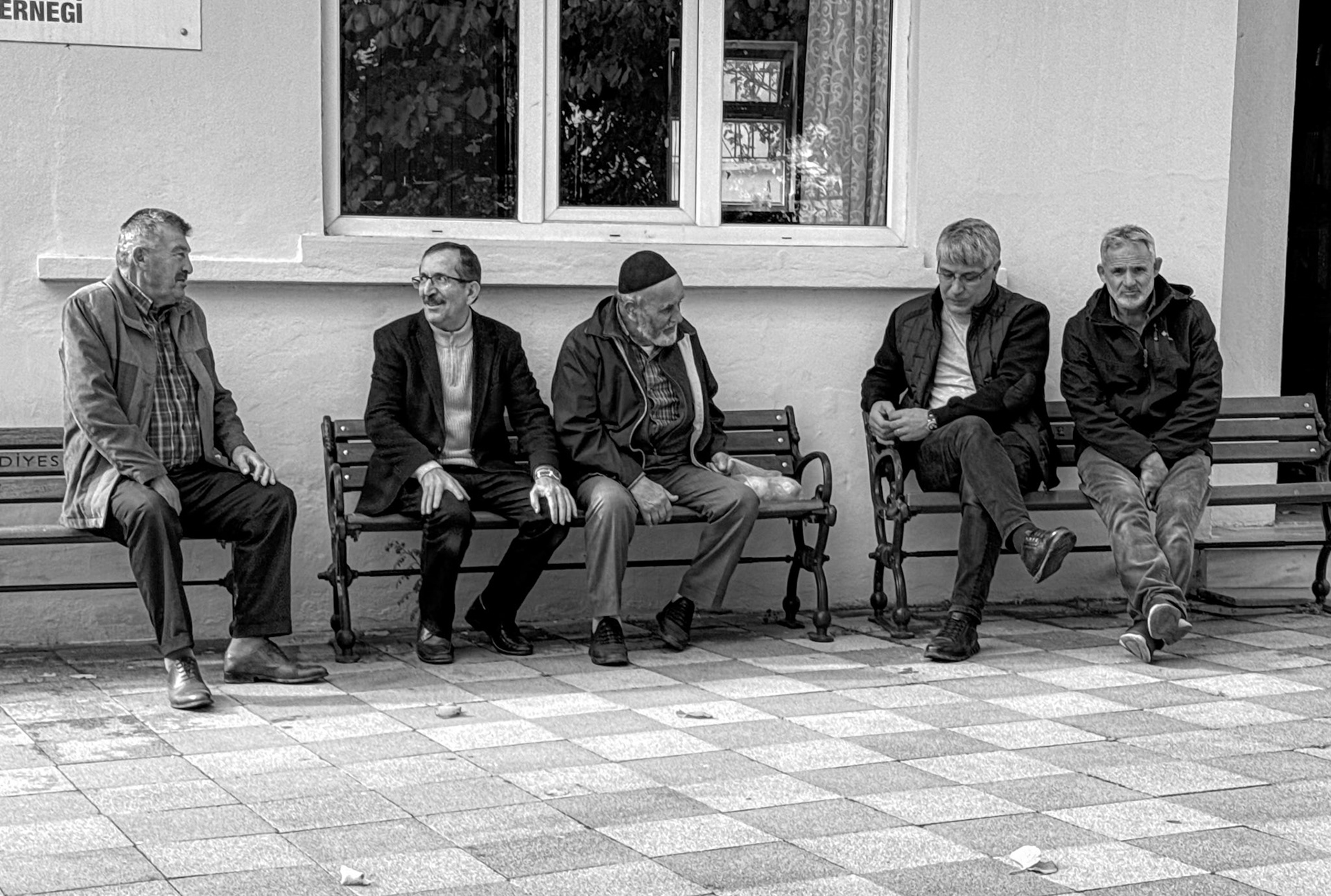 Doǧancılı mosque: men waiting to say prayers for a recently deceased