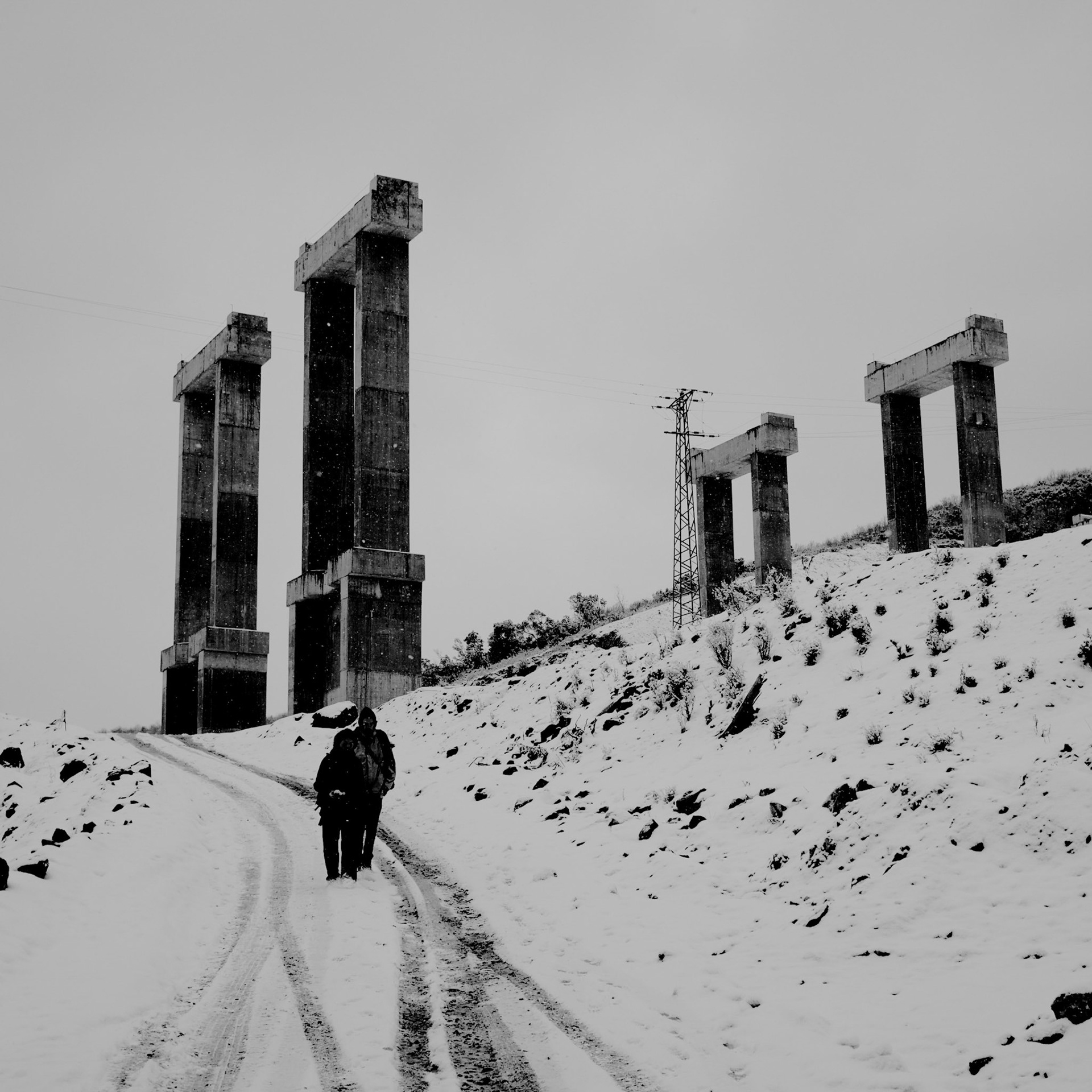snow-covered forest road running under the a viaduct under construction just north of Gümüşdere