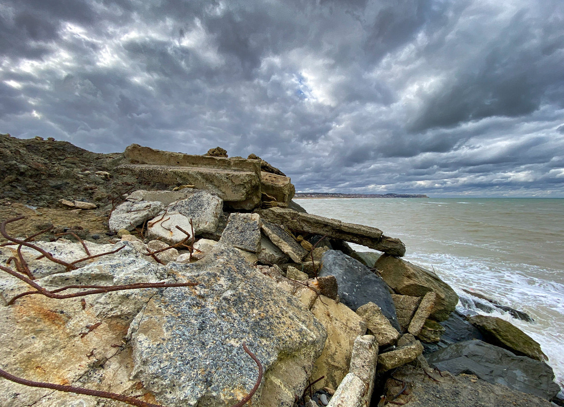 Yeniköy active mining area: cloudscape, dumpings and sea with Karaburun behind